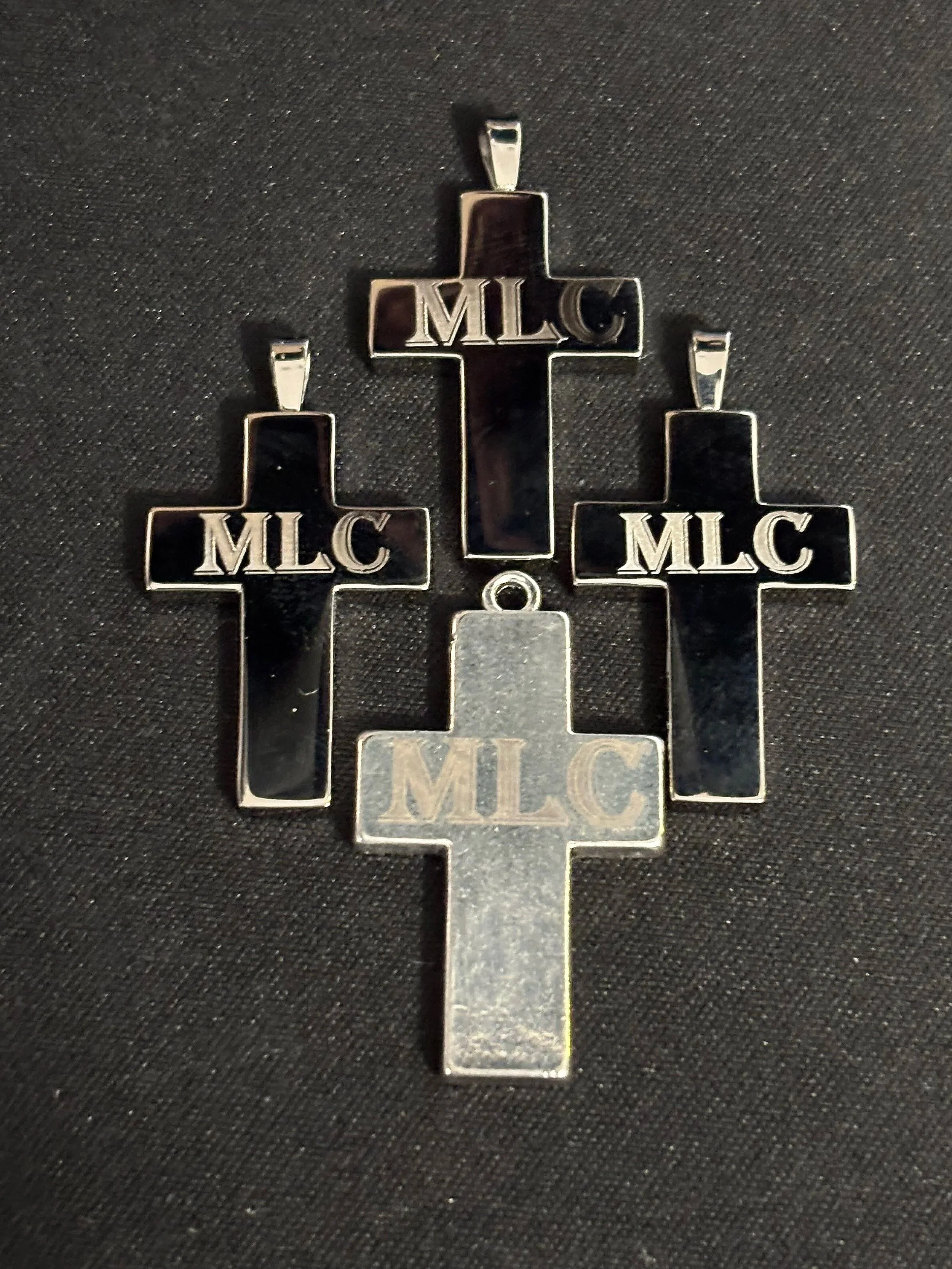 These custom crosses were engraved for a family honoring a lost loved one—each piece bearing the initials “MLC” as a quiet tribute. 