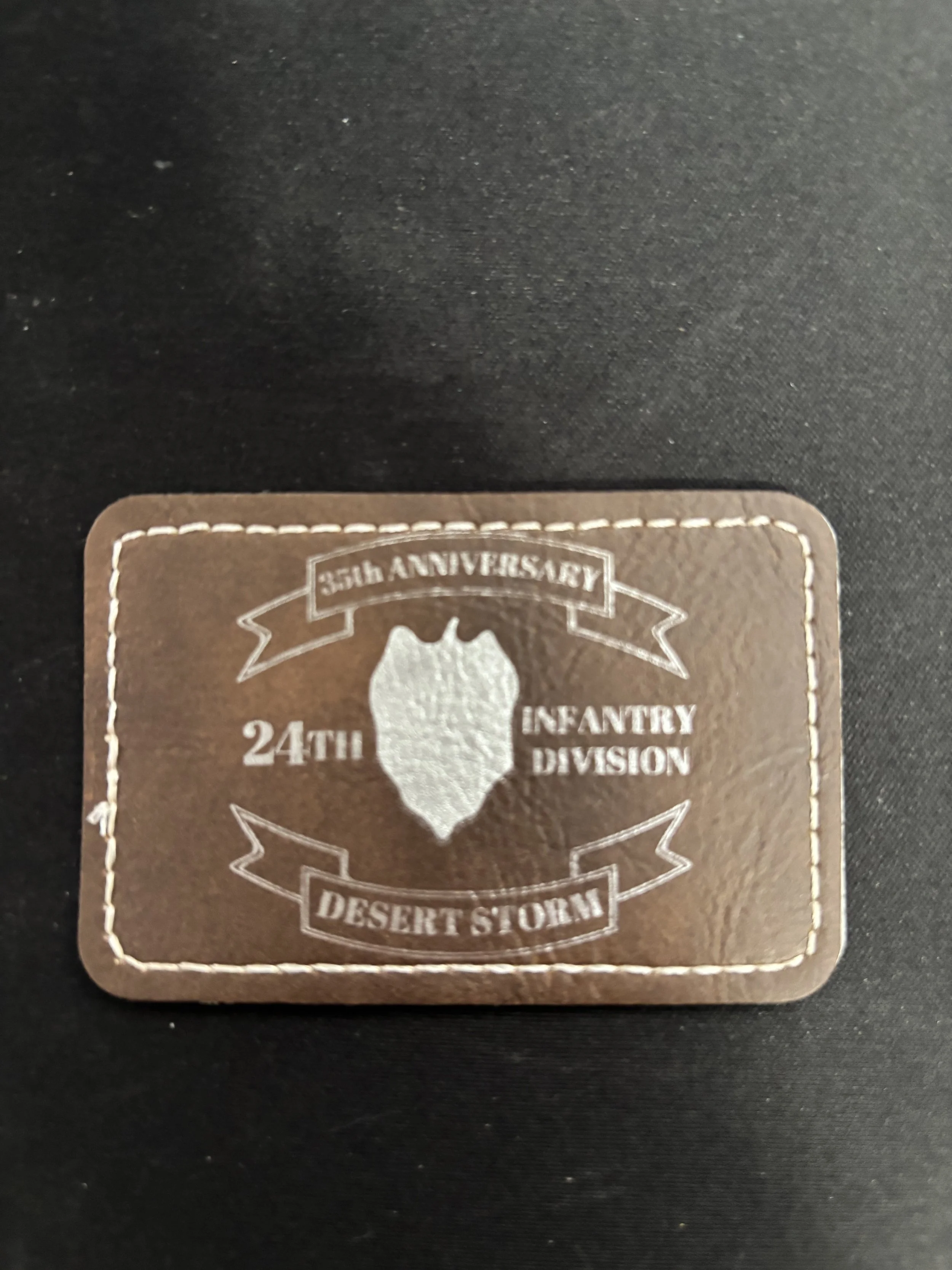 Militaria badge or patch with text and a shield emblem, celebrating the 35th anniversary of the 24th Infantry Division Desert Storm.