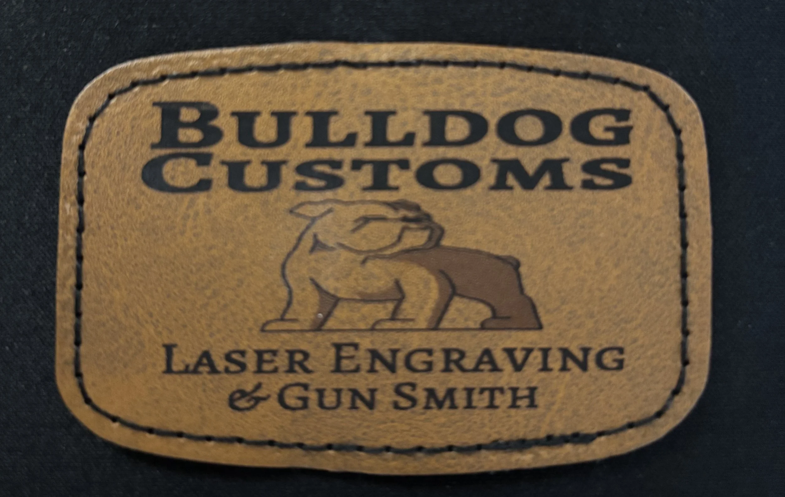 Leather patch with the text 'Bulldog Customs Laser Engraving & Gun Smith' and an illustration of a bulldog.