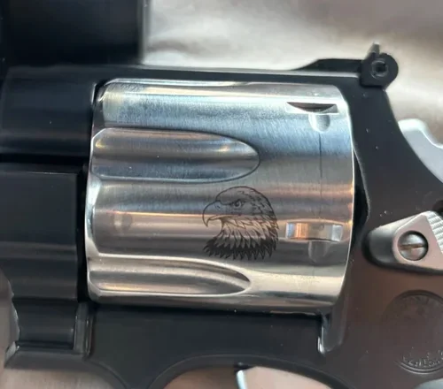Polished revolver cylinder engraved with a bold eagle’s head—custom detail that speaks to power and pride.