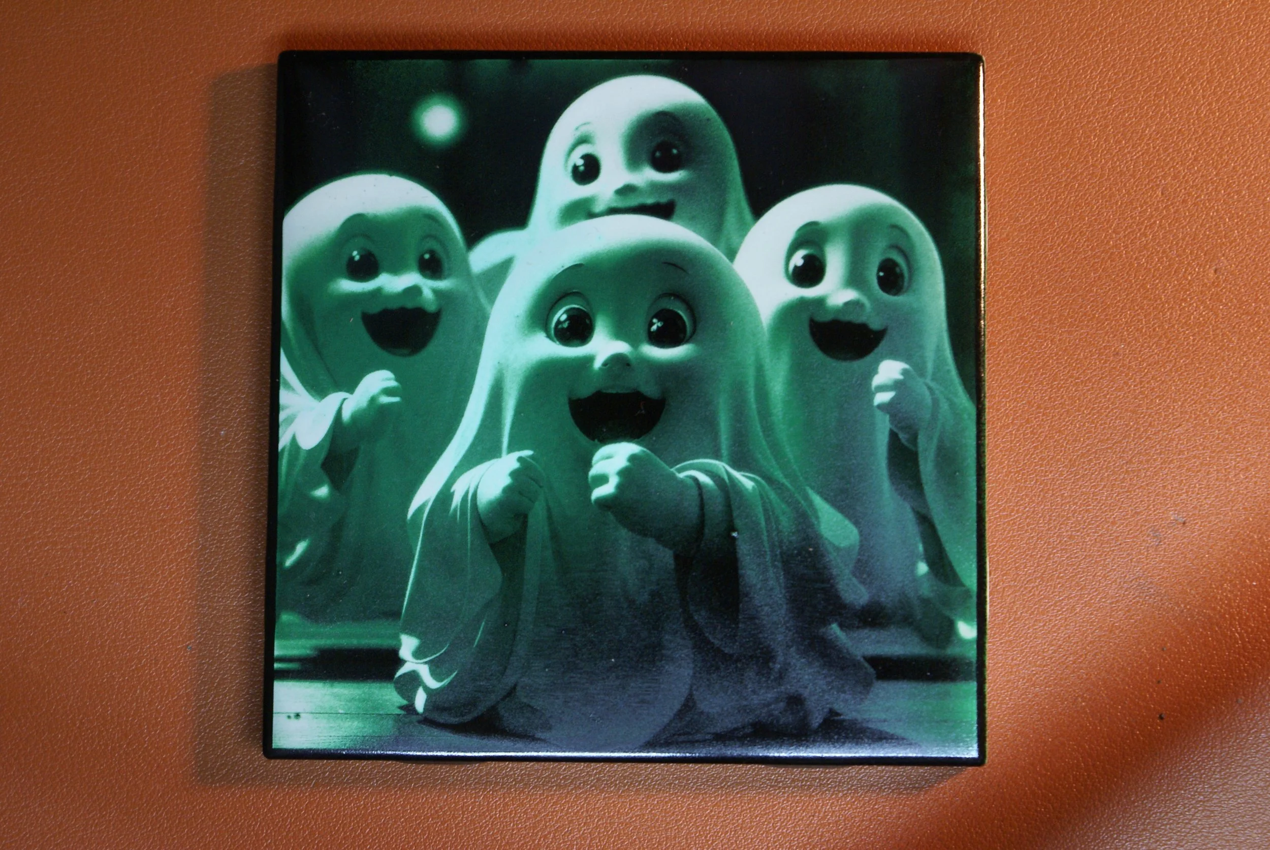 A box with cartoon ghost characters with big eyes and open mouths, smiling and looking cheerful.