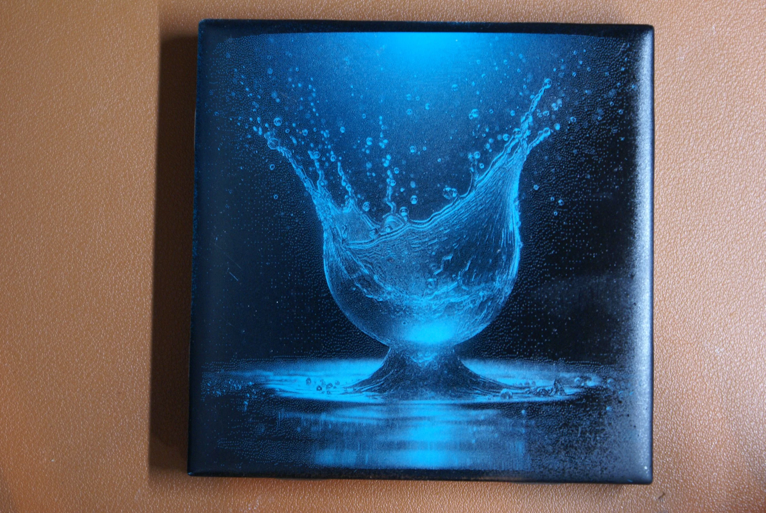 A painting of a water splash in a glass.