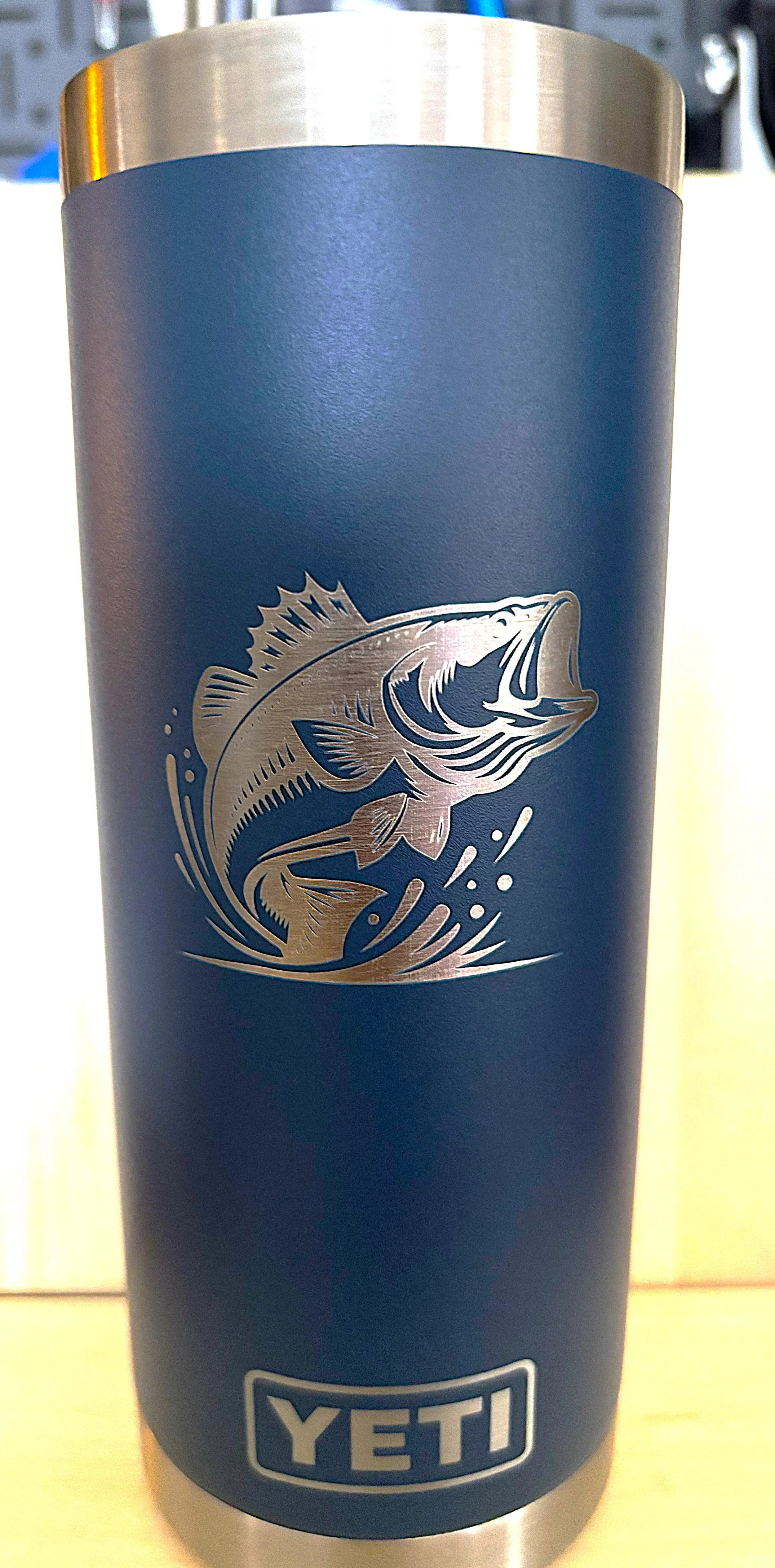 Blue YETI tumbler with a silver fish design and the YETI logo at the bottom.