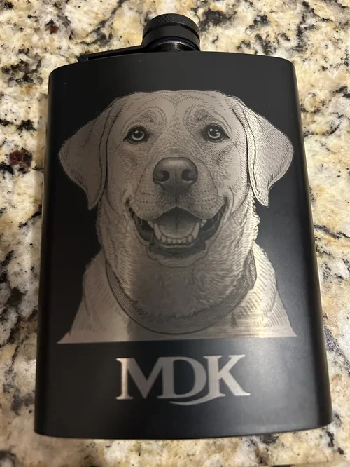 Engraved black flask customized from a customer’s photo—featuring their dog’s portrait and initials. 