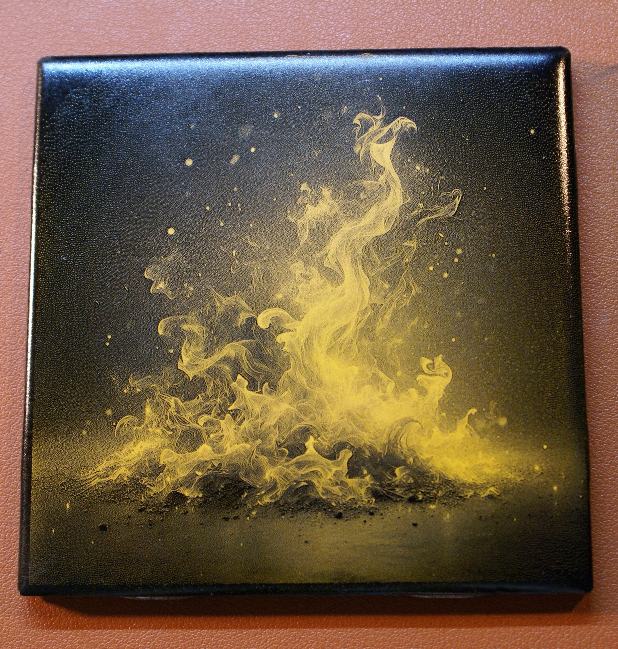 A black square canvas with gold and yellow abstract smoke or ink swirling upwards, creating a dynamic, fiery effect.