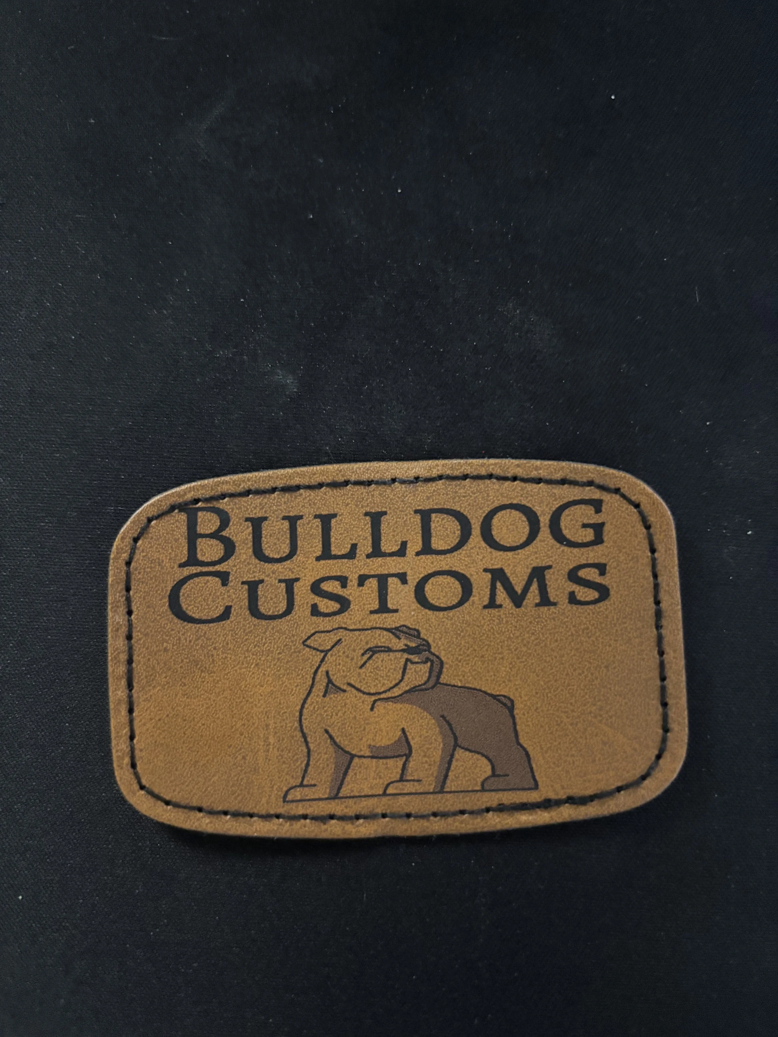 Leather patch with the words "Bulldog Customs" and an illustration of a bulldog.