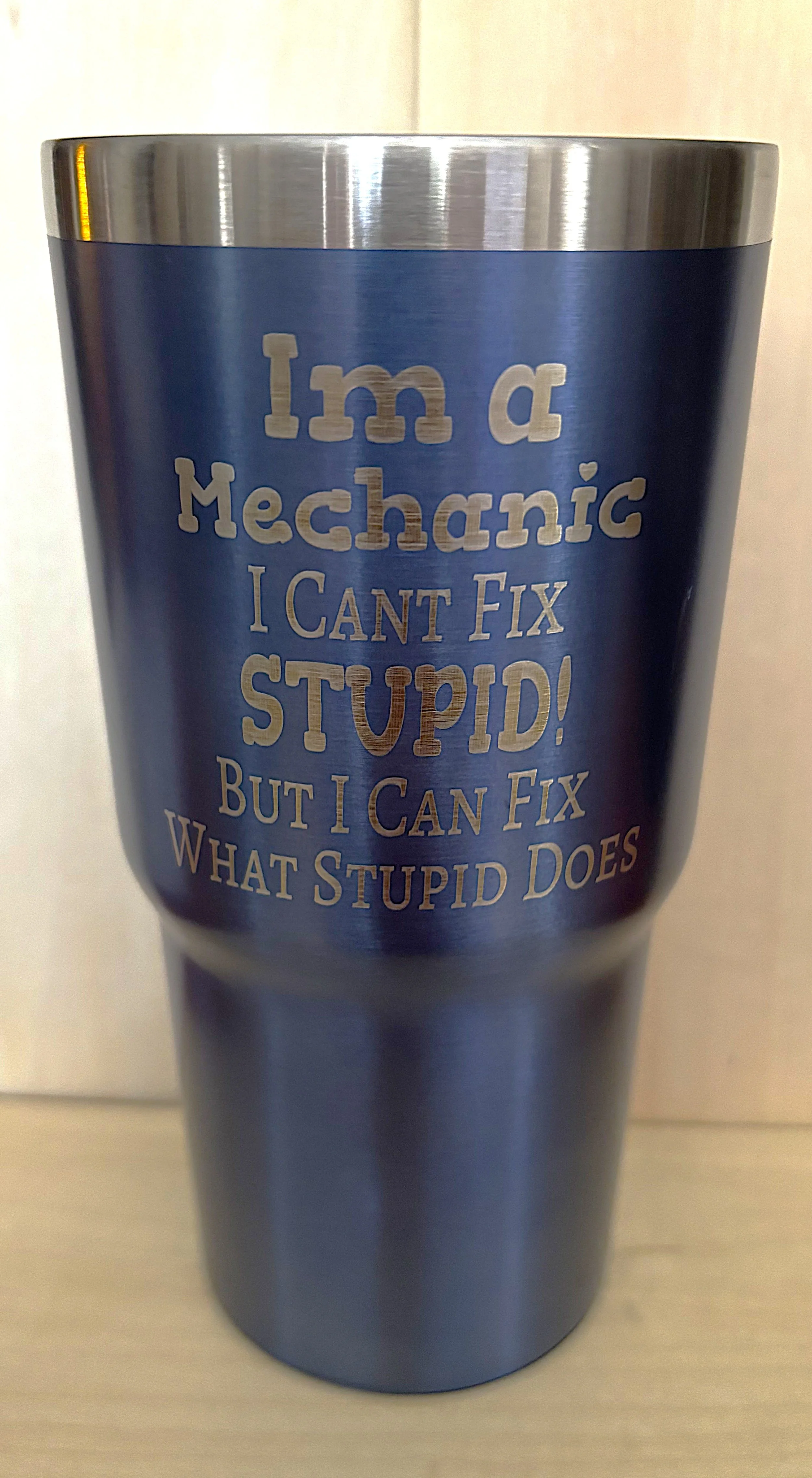 A metallic blue tumbler with an inspirational quote about fixing mistakes.