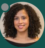A woman with curly hair smiling at the camera.