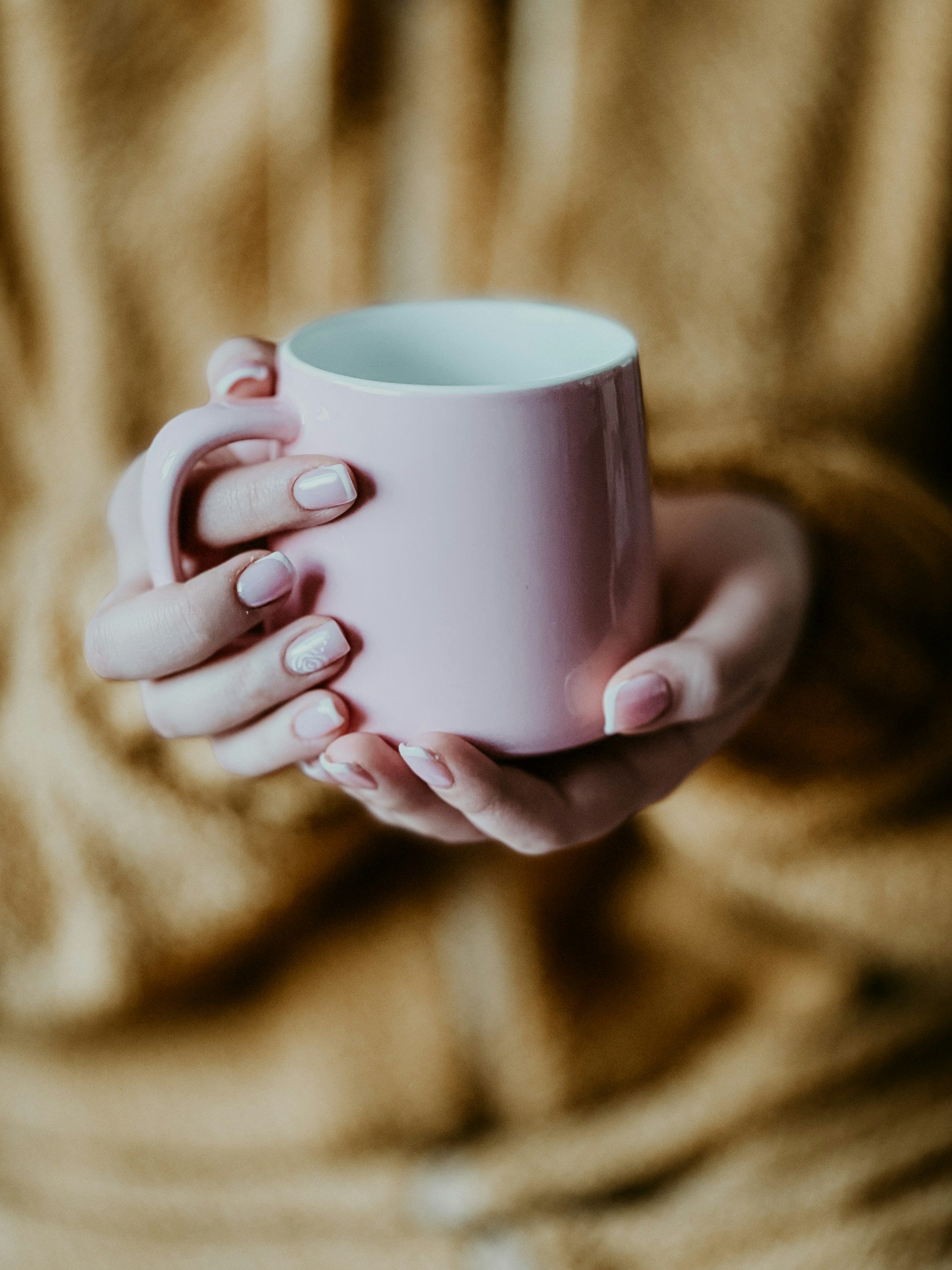Adult holding mug