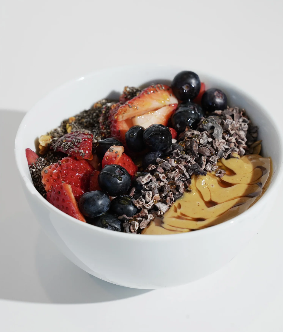 Our rich açaí base comes ready for you to customize with your favorite toppings. Choose from almond butter, peanut butter, coconut flakes, bananas, blueberries, strawberries, cacao nibs, chia seeds, and honey. Mix, match, and create your perfect bowl