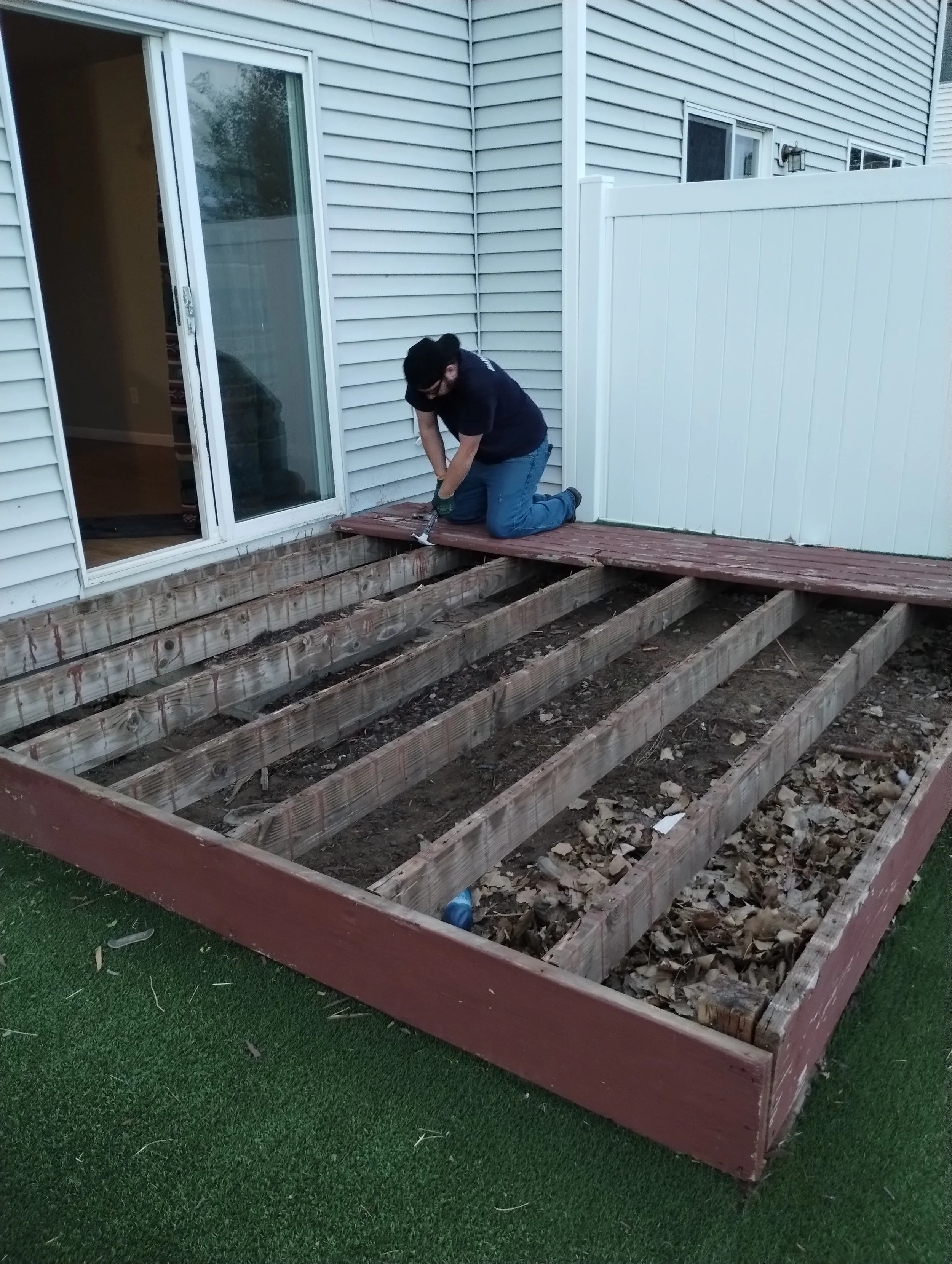 Stripping off the old deck boards to get do the frame beneath
