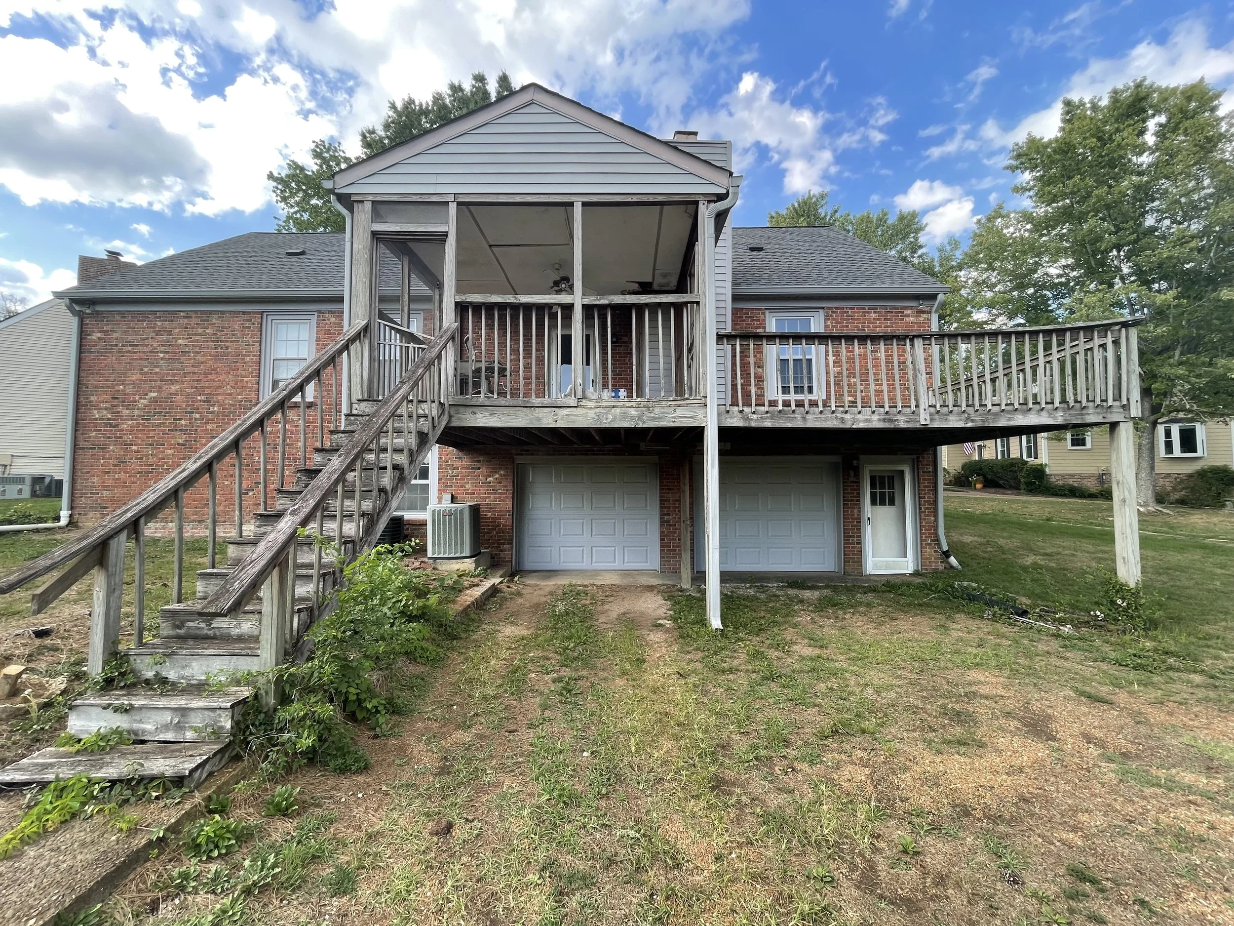 Before picture showcasing a large covered old wood deck needing to be refinished located in Cottonwood, Franklin, Tennessee