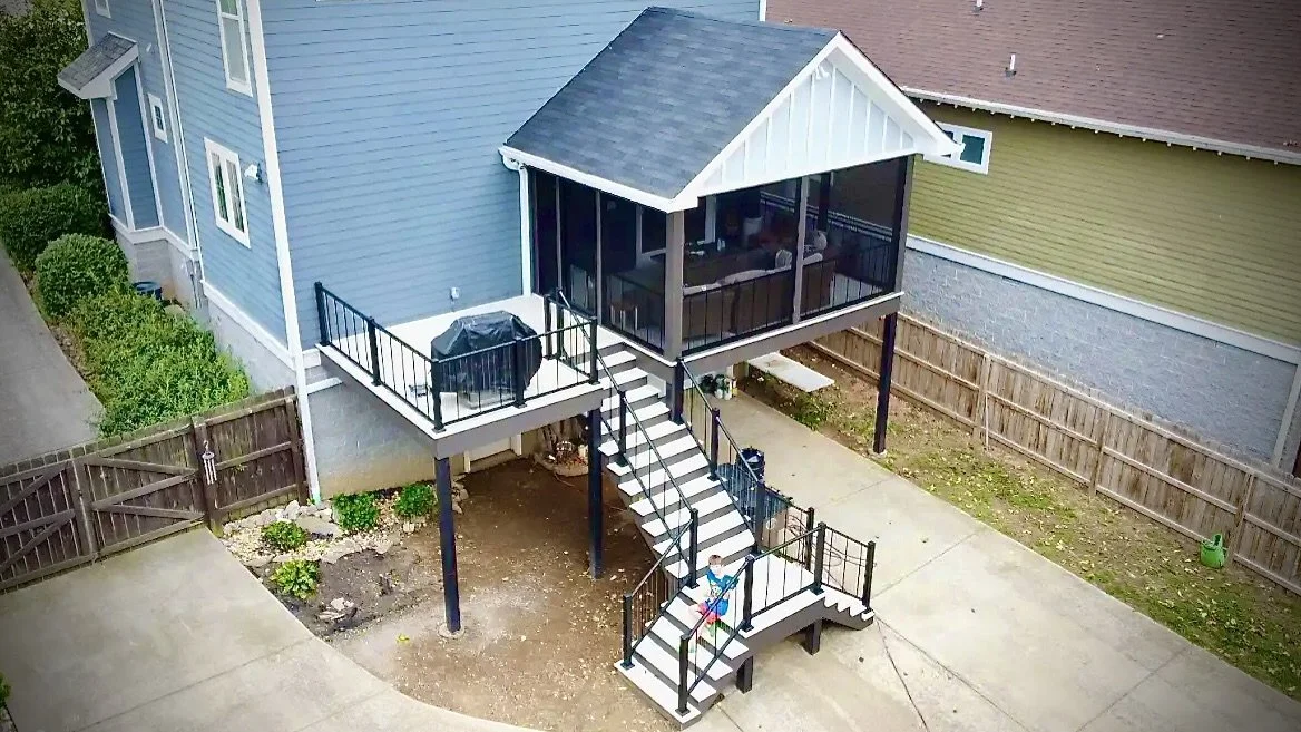 Large gray craftsman-style home showcasing a new composite deck built by Deck Craft using TimberTech Decking. 