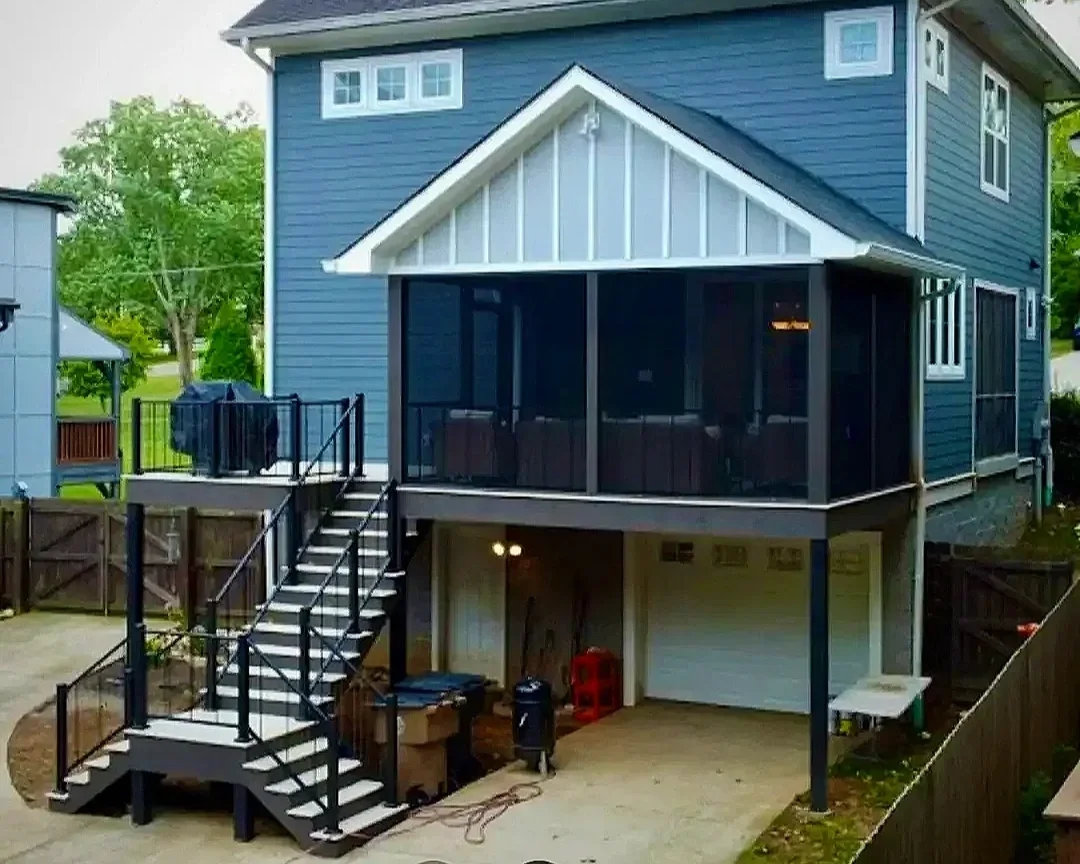 Large gray craftsman-style home showcasing a new composite deck built by Deck Craft using TimberTech Decking. 