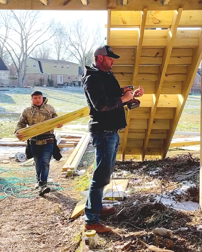 Deck Craft owner is holding a drill working on building a new deck in the Cottonwood neighborhood, Franklin, TN