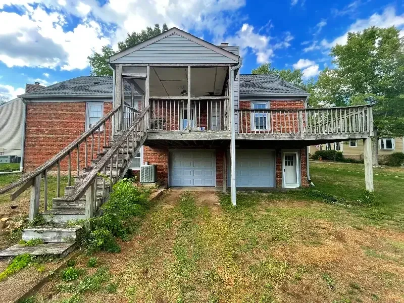 Before picture showcasing a large covered old wood deck needing to be refinished located in Cottonwood, Franklin, Tennessee