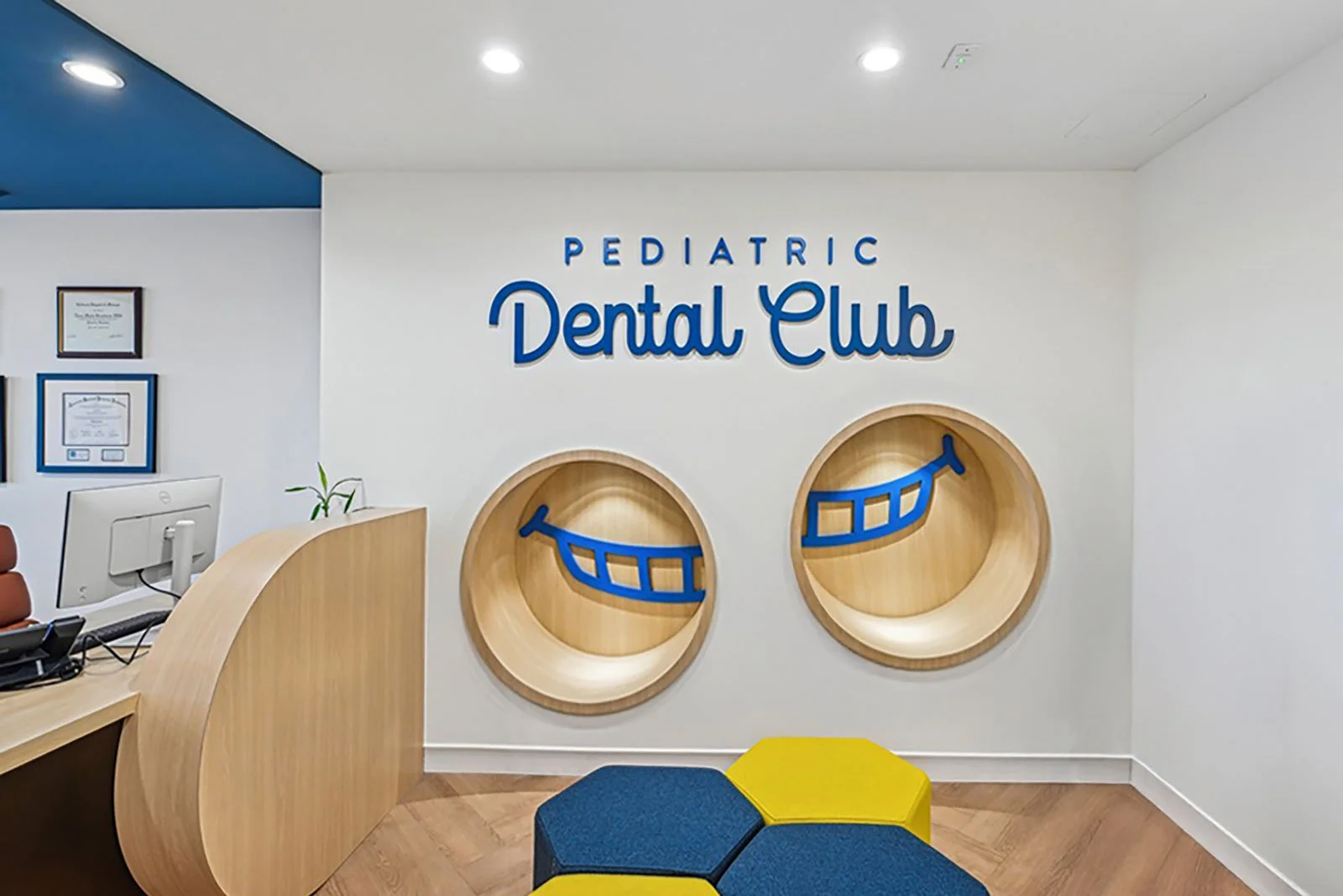 Pediatric dental lobby with integrated seating nooks branded with logo