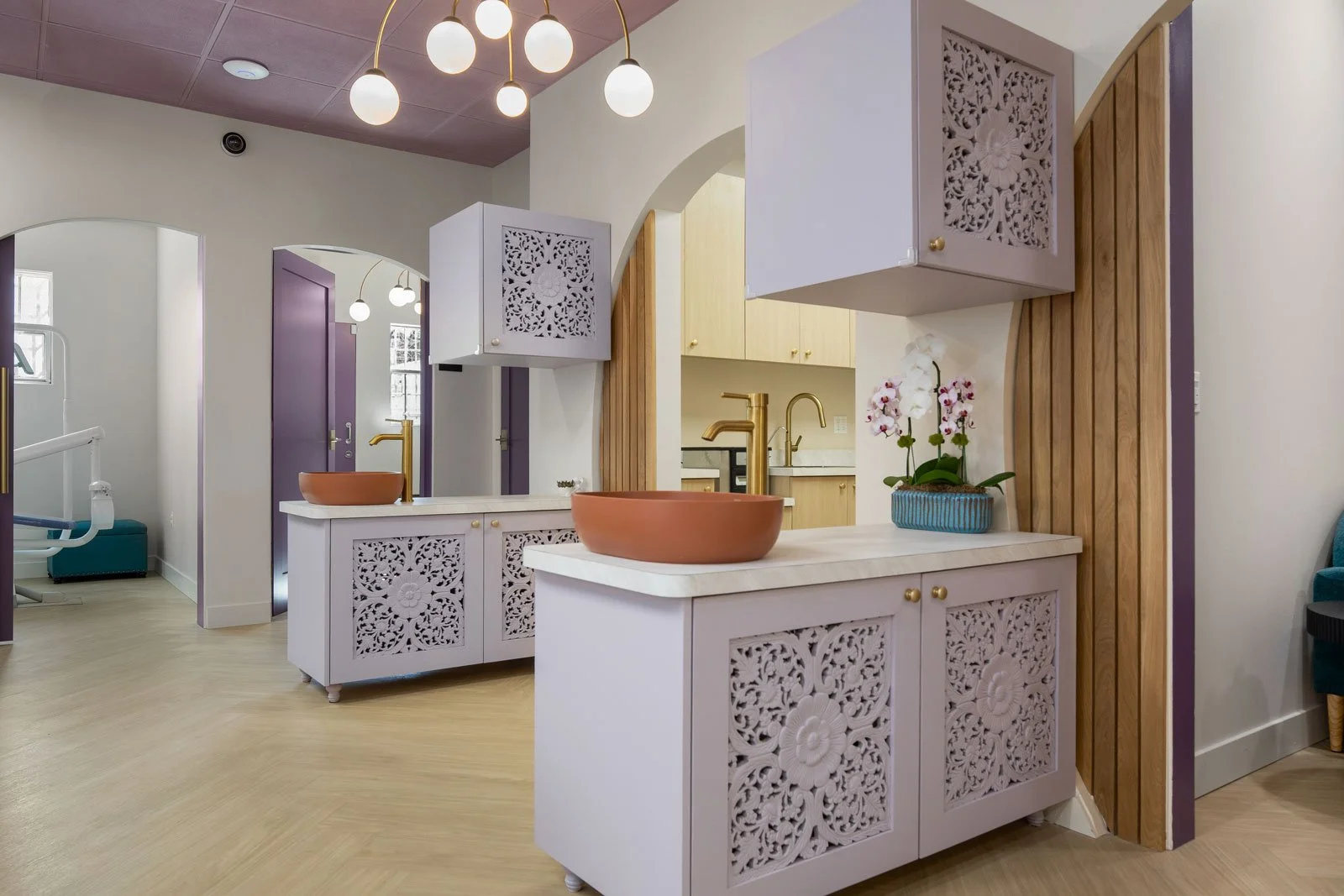Custom cabinetry for handwashing station of pediatric dental office incorporating storage for dentist overflow of materials. 