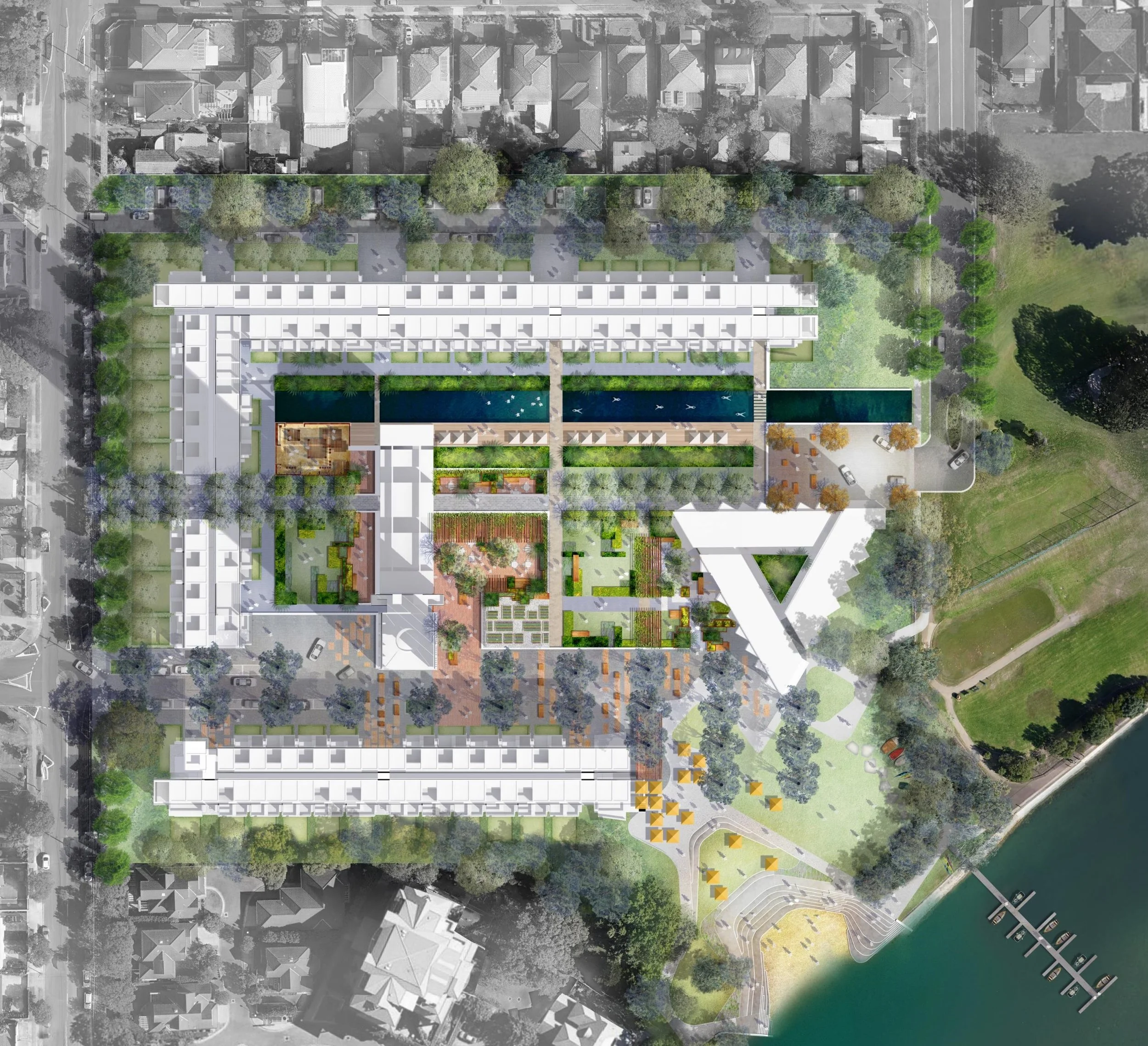 Aerial view of a modern urban park and residential complex with green spaces, water features, pathways, and surrounding city streets.