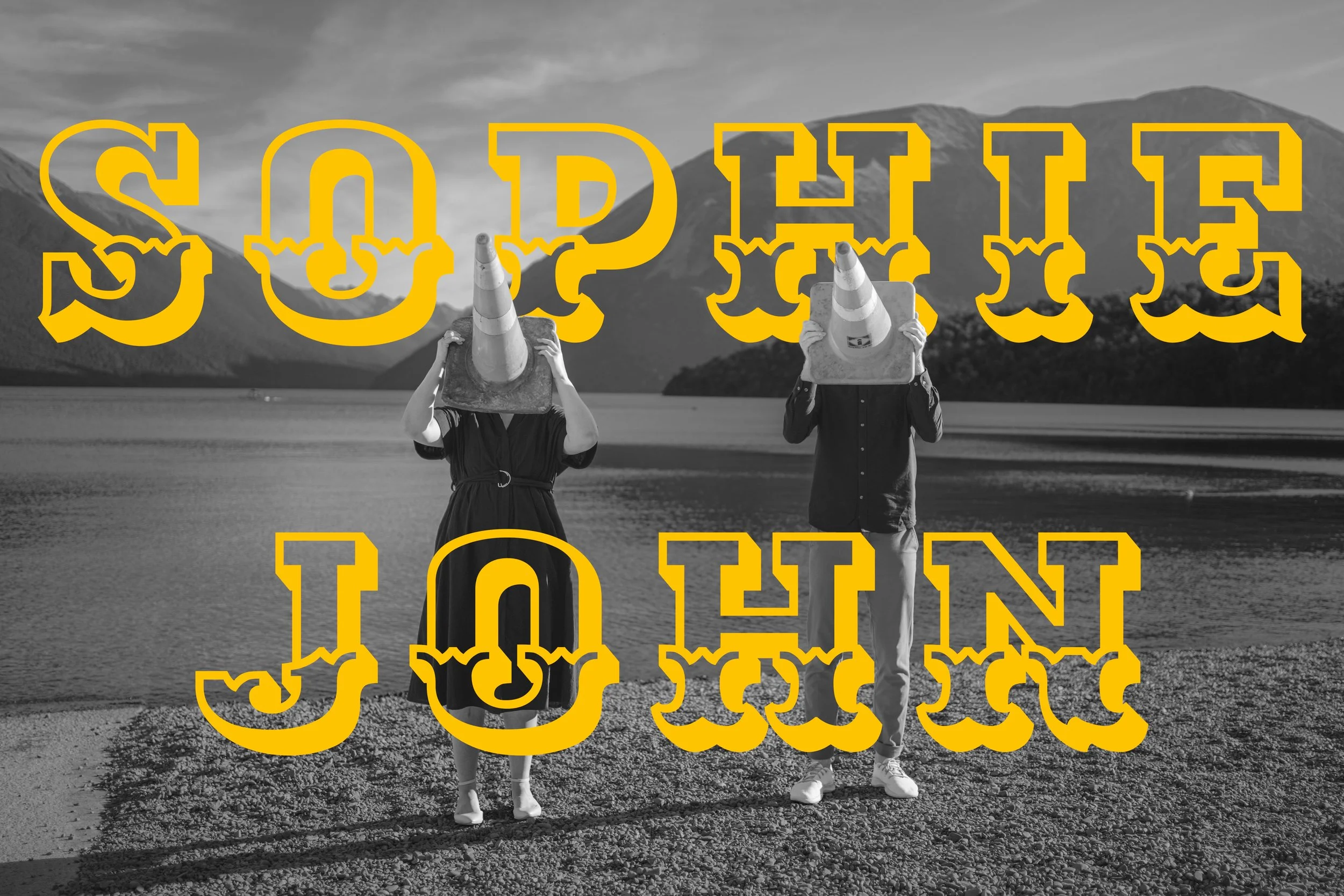 Two people walking on a beach holding traffic cones in front of their faces; overlaid with the bold, yellow text 'SOPHIE' at the top and 'JOHN' at the bottom
