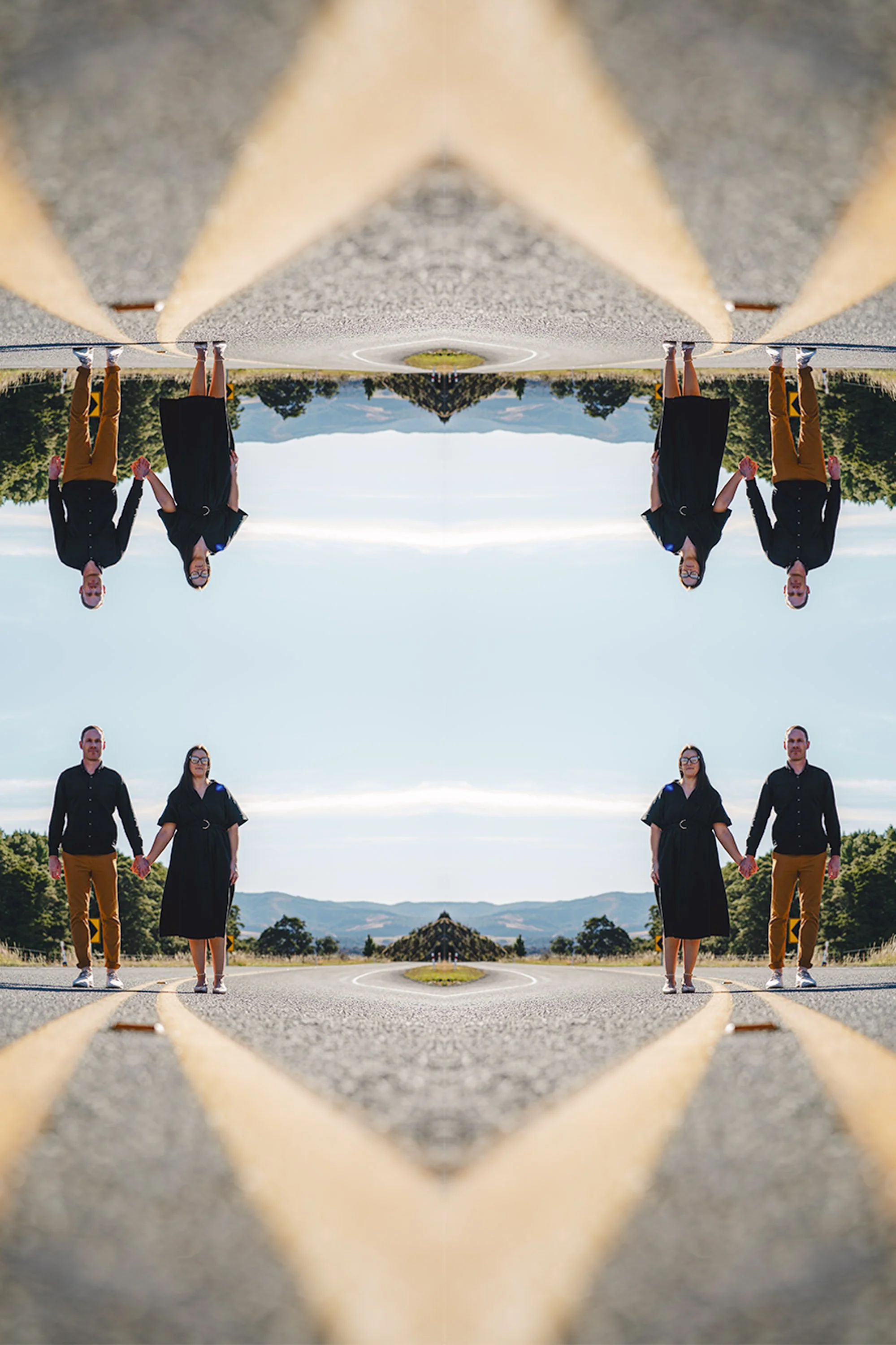 A symmetrical, mirrored image of a man and woman holding hands, walking on a road with mountains and trees in the background.