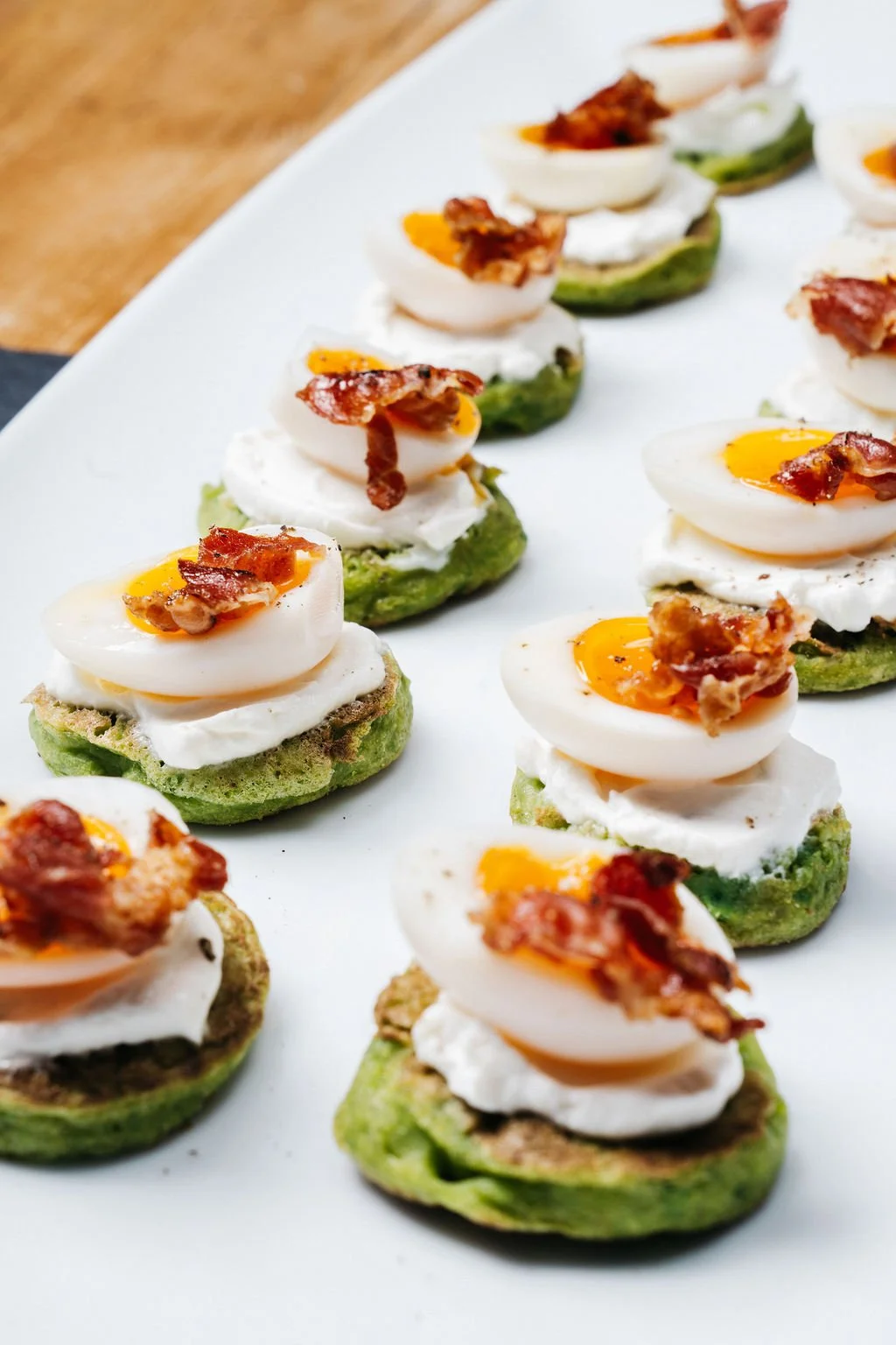 Green pea blini, creme fraiche, quails egg, pancetta