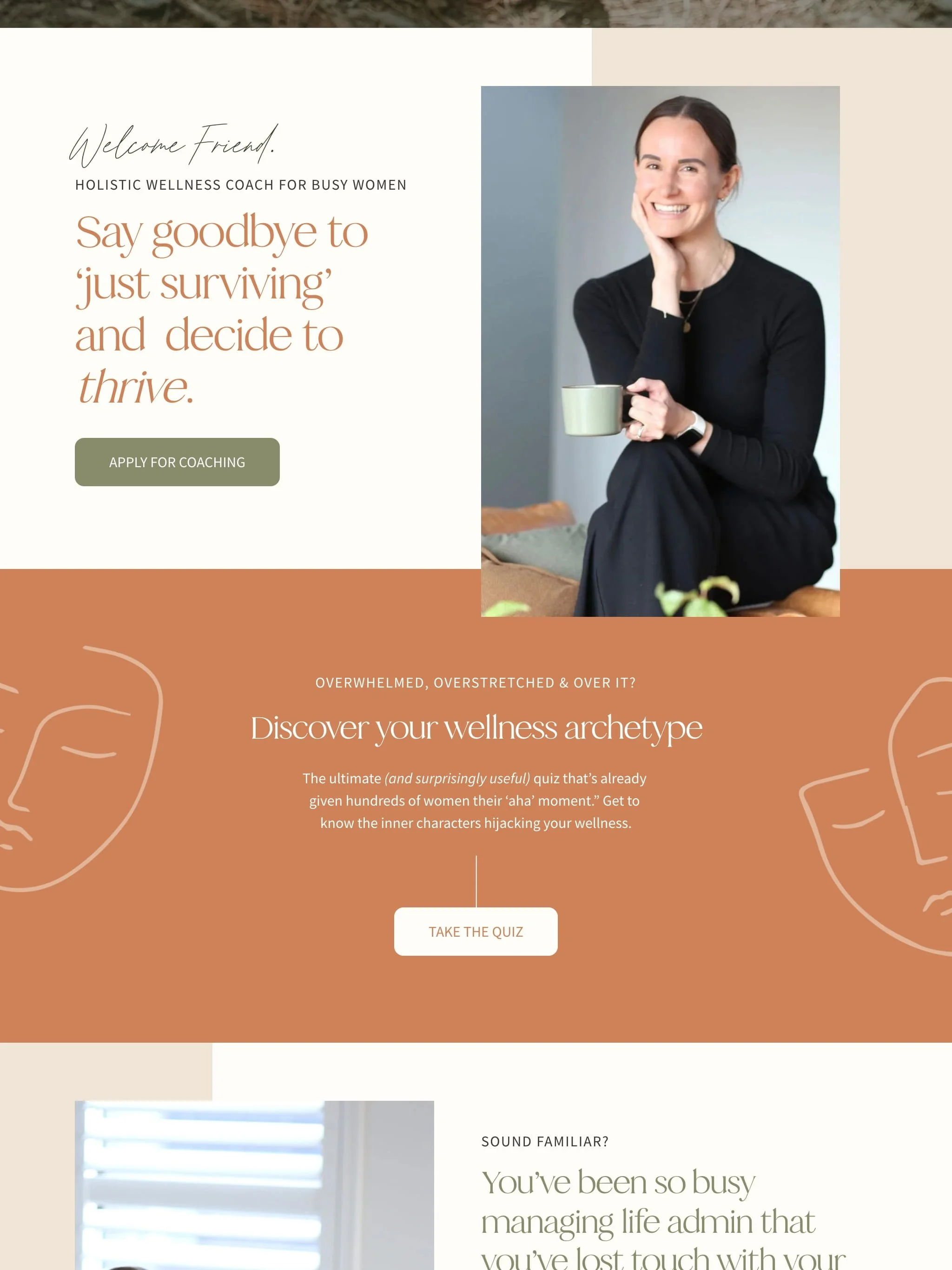 A woman with brown hair, wearing a black long sleeve shirt, sitting on a sofa, holding a coffee mug, smiling at the camera.