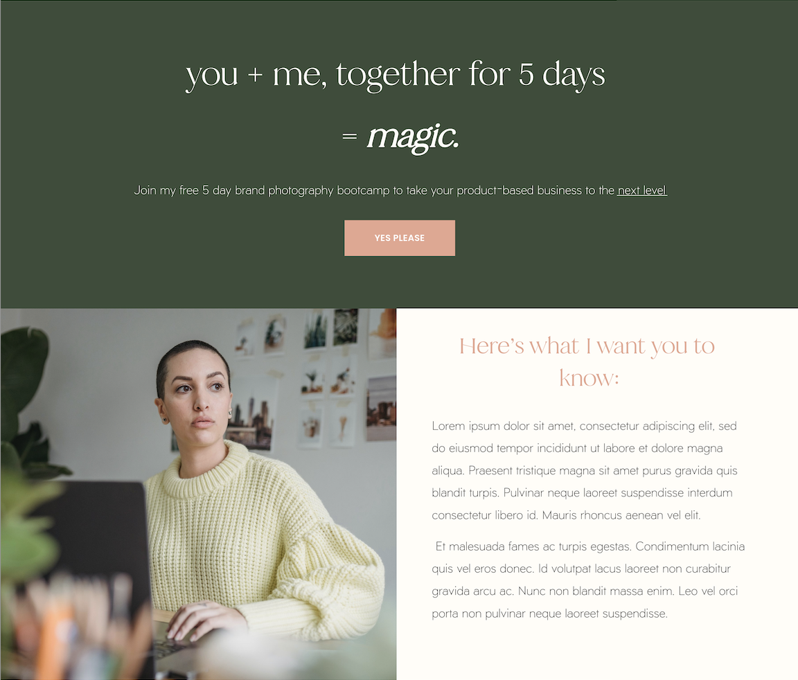 A woman with dark hair tied back, wearing a yellow sweater, sitting at a desk with a laptop, in a room with framed pictures on the wall behind her.