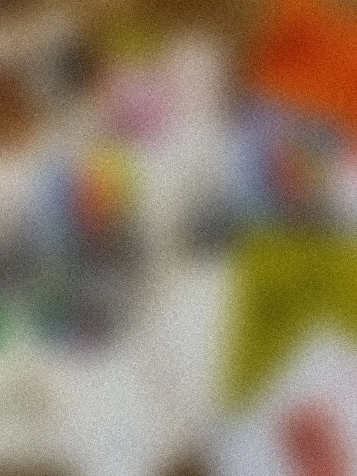 Blurred colorful pattern with no discernible objects.