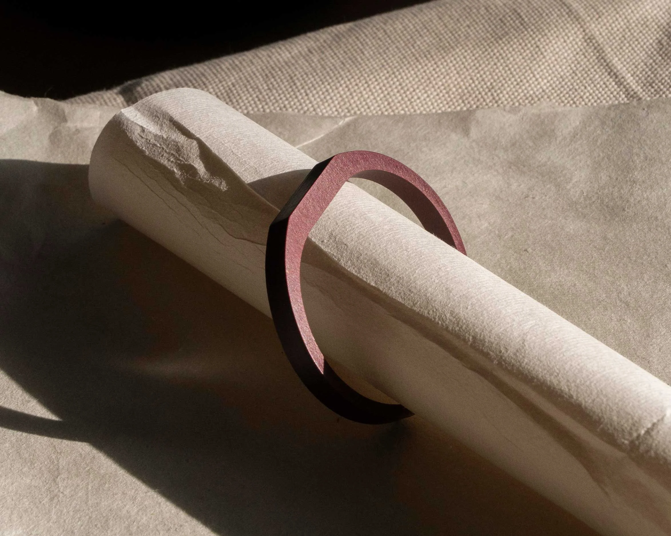 A clean sculpted bracelet for daily wear, handmade in London from compressed paper composite. Light in weight and smooth on the skin, it has a dense matte surface with quiet depth and a restrained, precise form.