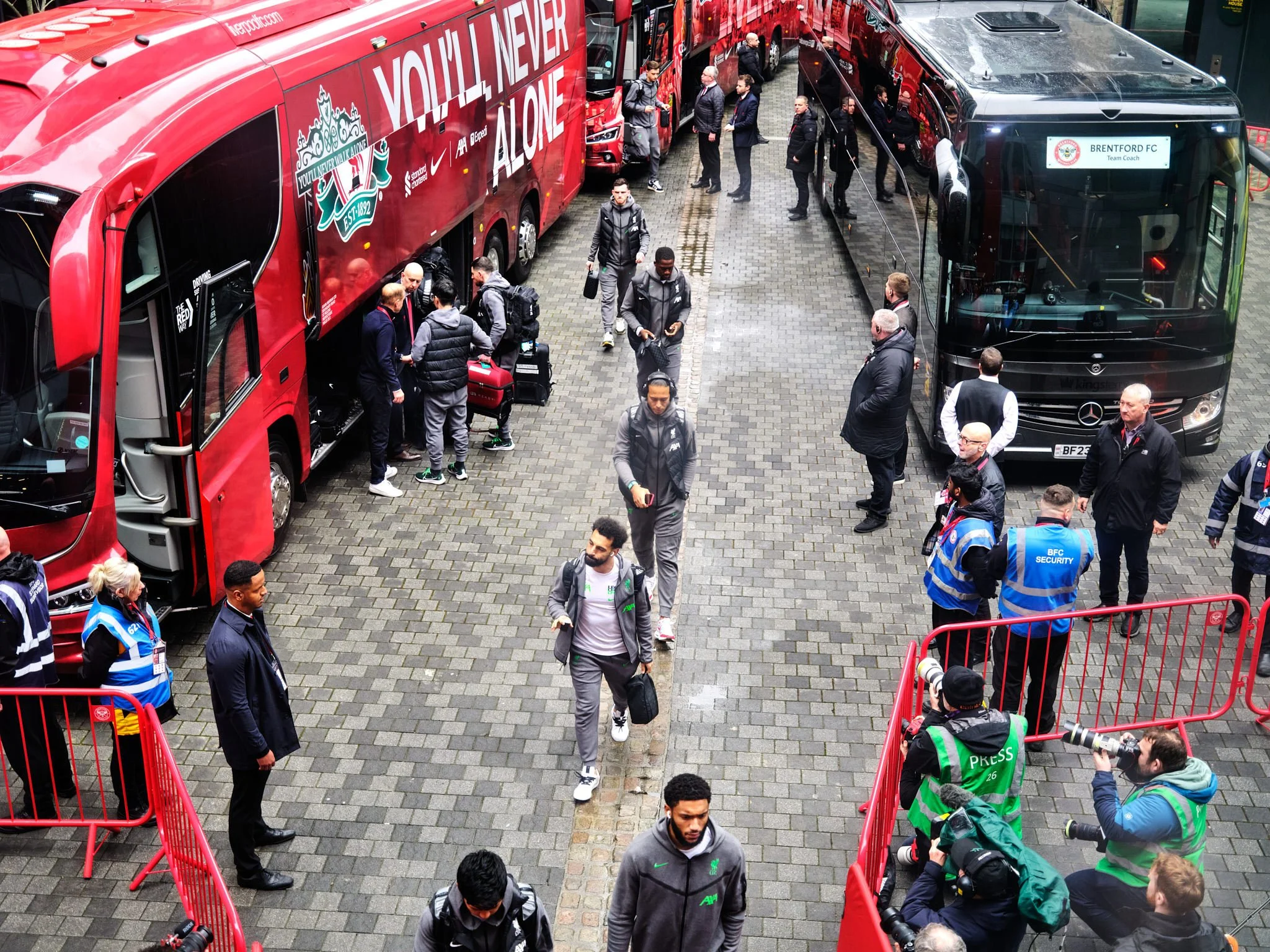 Salah, Van Dijk and other football players walking from Liverpool FC team bus at Brentford FC Gtech Community Stadium, photography by Premier Stadium Images