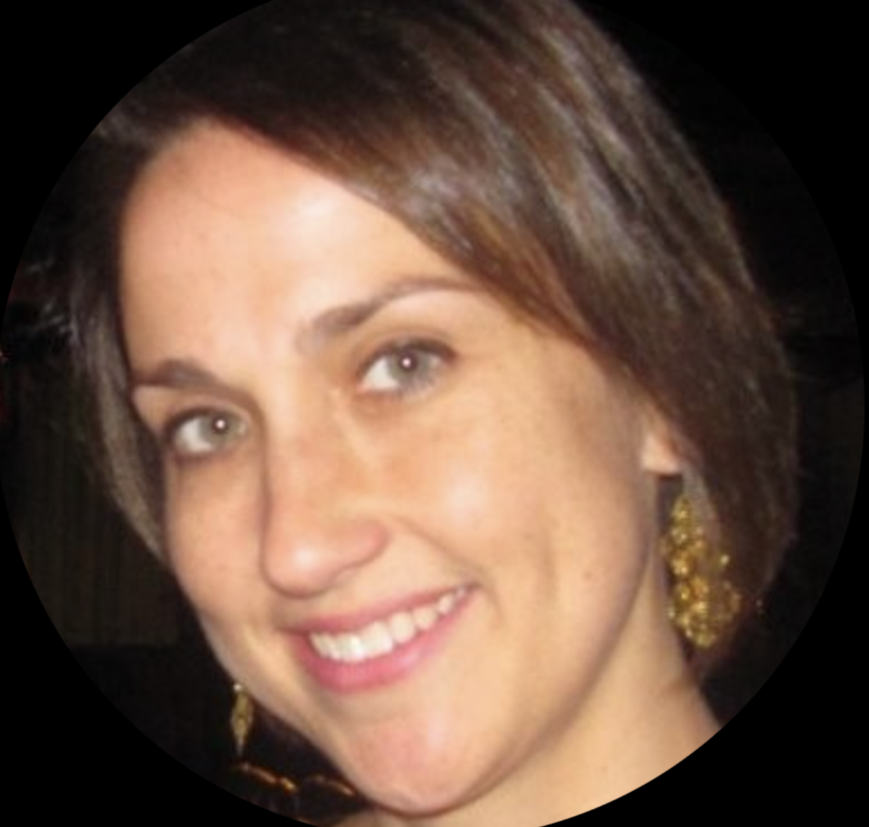 Close-up of a smiling woman with short brown hair, wearing gold earrings.