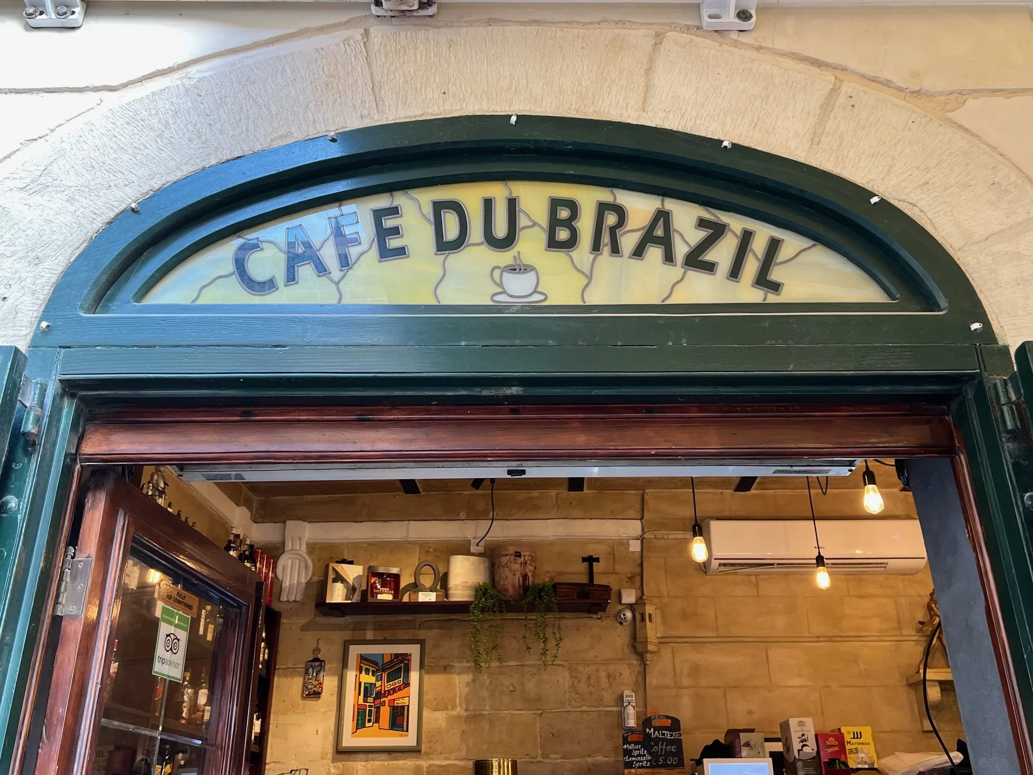 Vintage glass entrance of Café du Brazil located at Victory Square in Birgu.