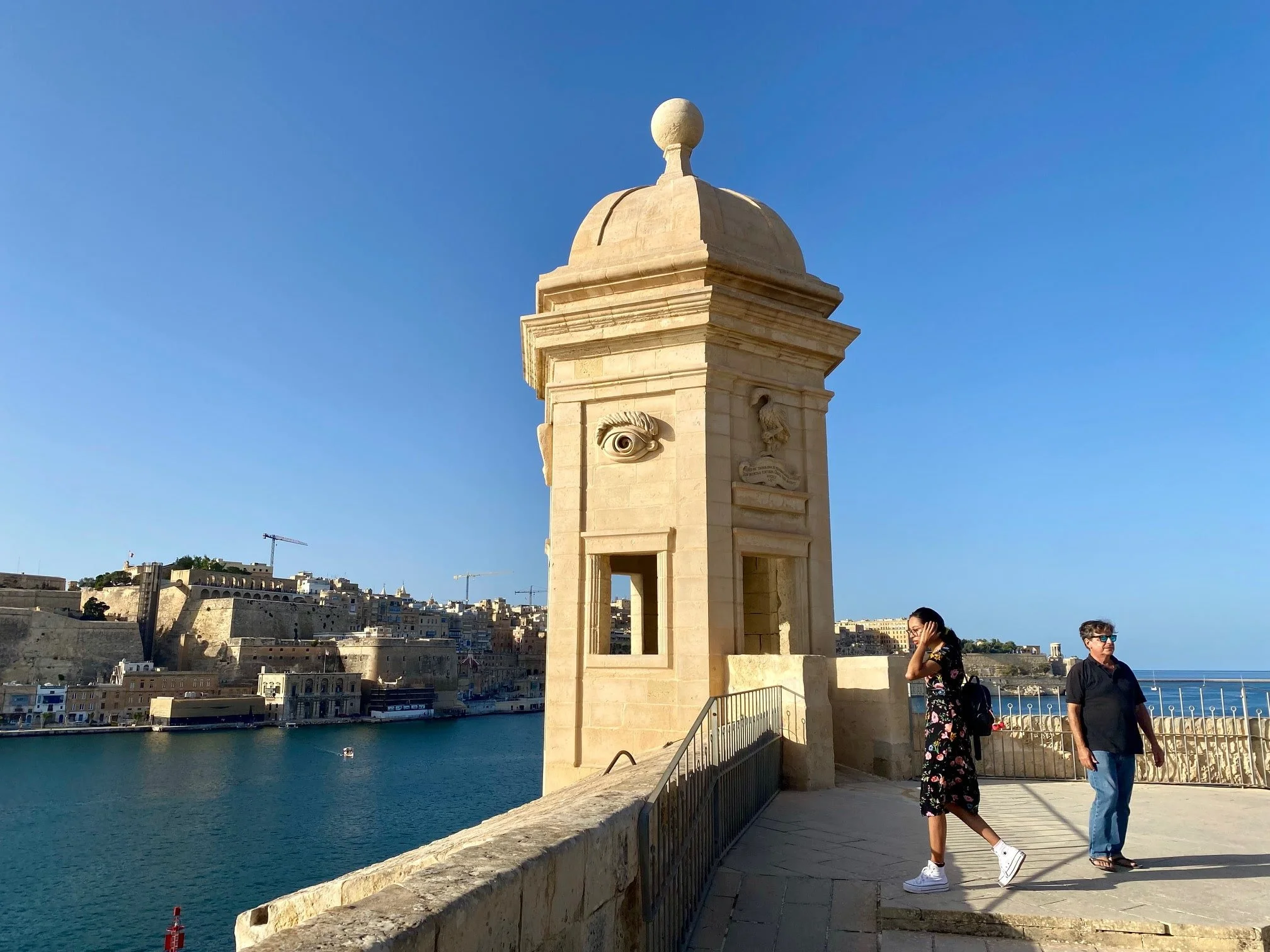Tourists visiting the iconic Gardjola watchtower in Senglea Gardens overlooking the Grand Harbour.