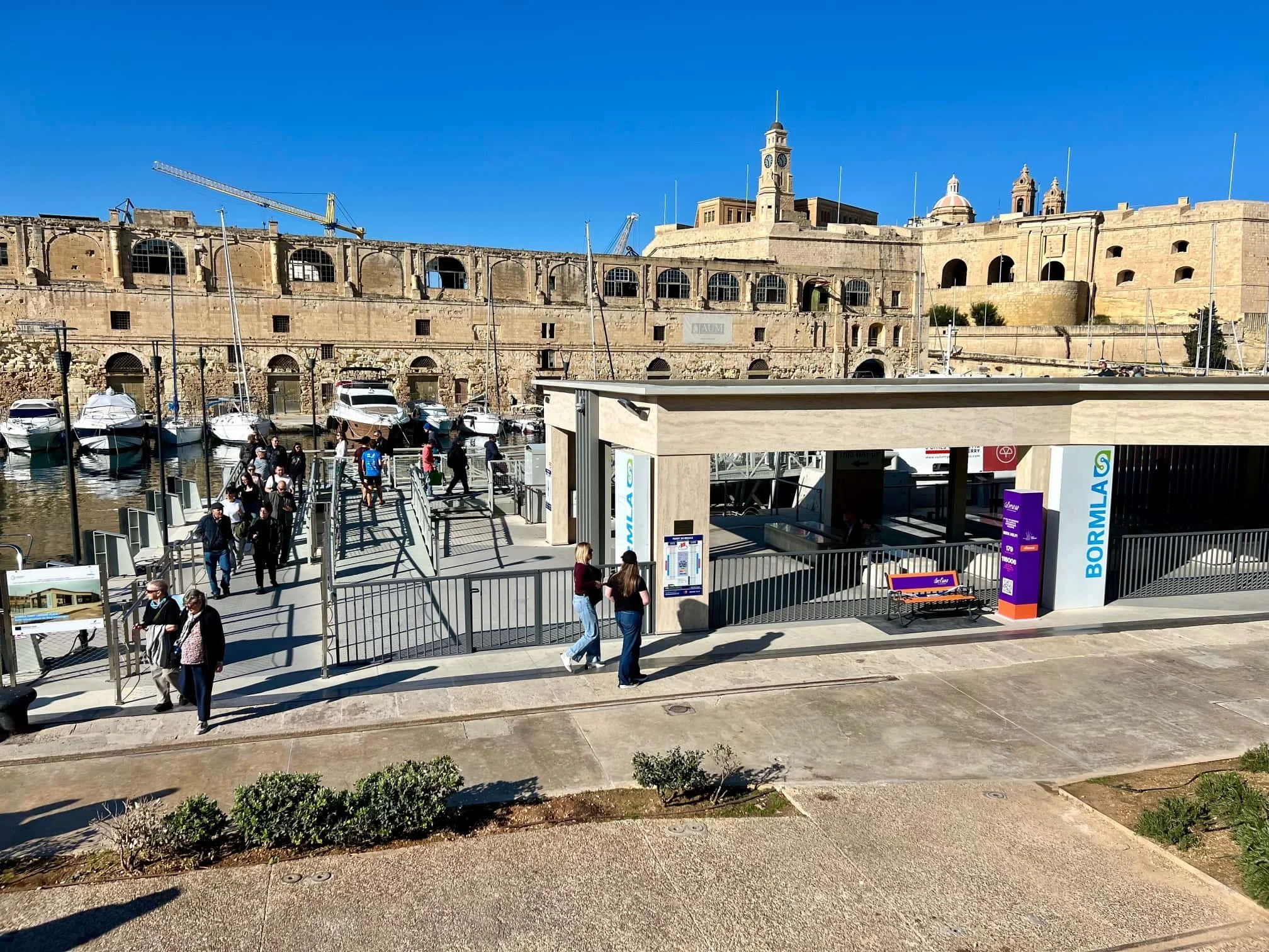 The Valletta ferry landing point at Dock 1 in Cospicua, showing the modern catamaran terminal and the historic waterfront of the Three Cities.