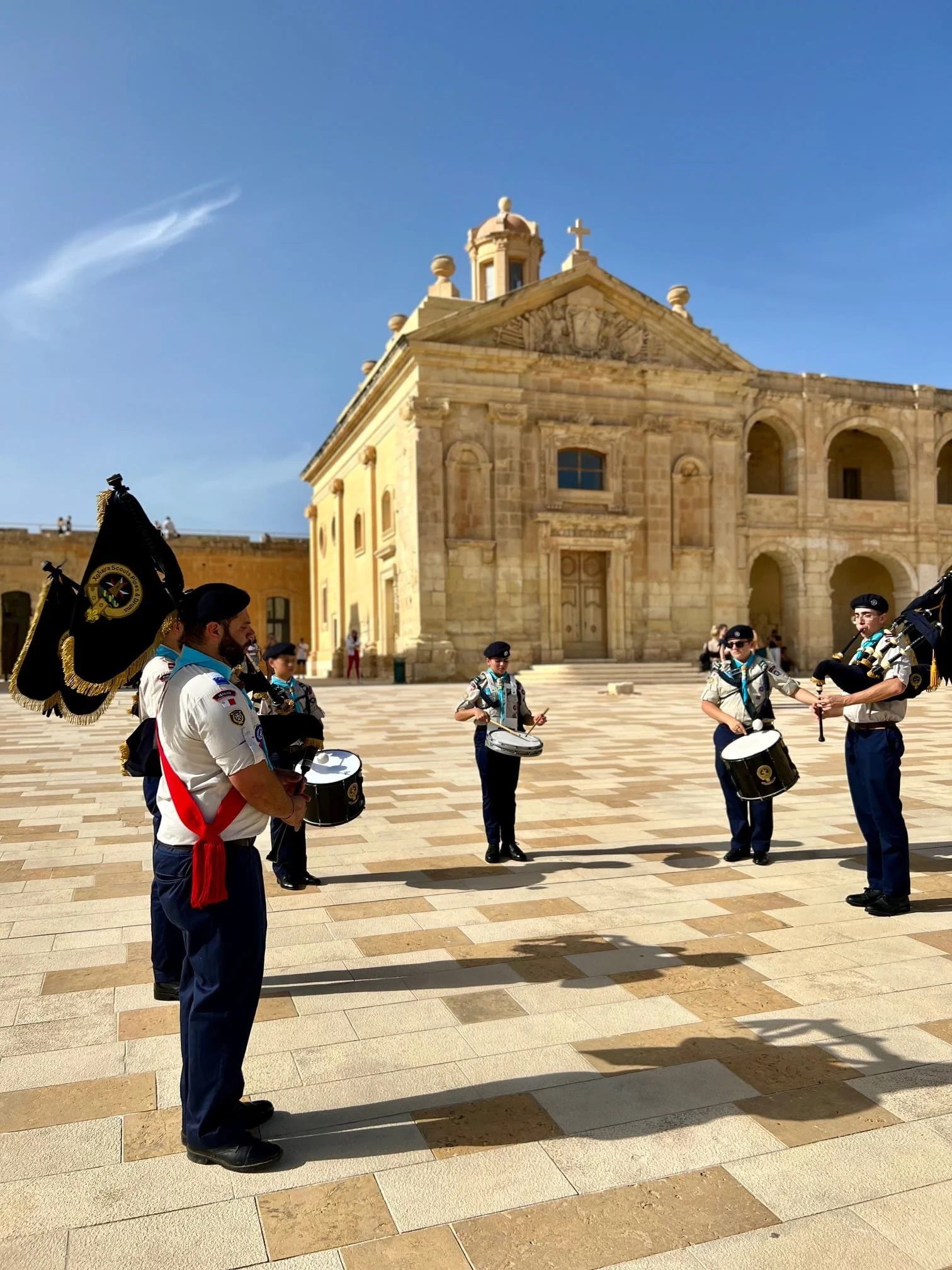Bagpipers and drummers performing inside the historic courtyard of Fort Manoel.
