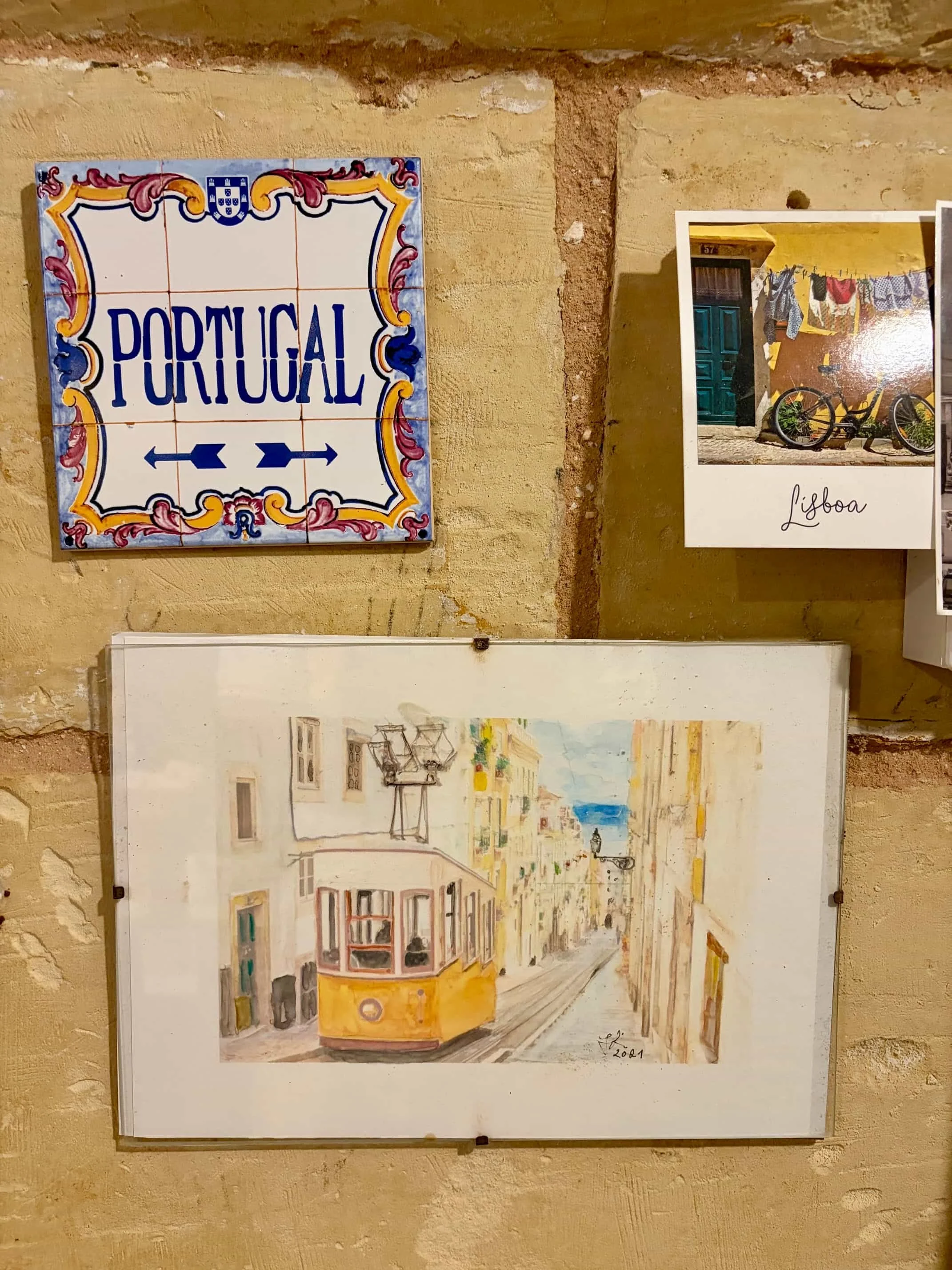 Traditional Portuguese ceramic tiles and framed art on the wall at Coffee Circus Lisboa, Valletta.