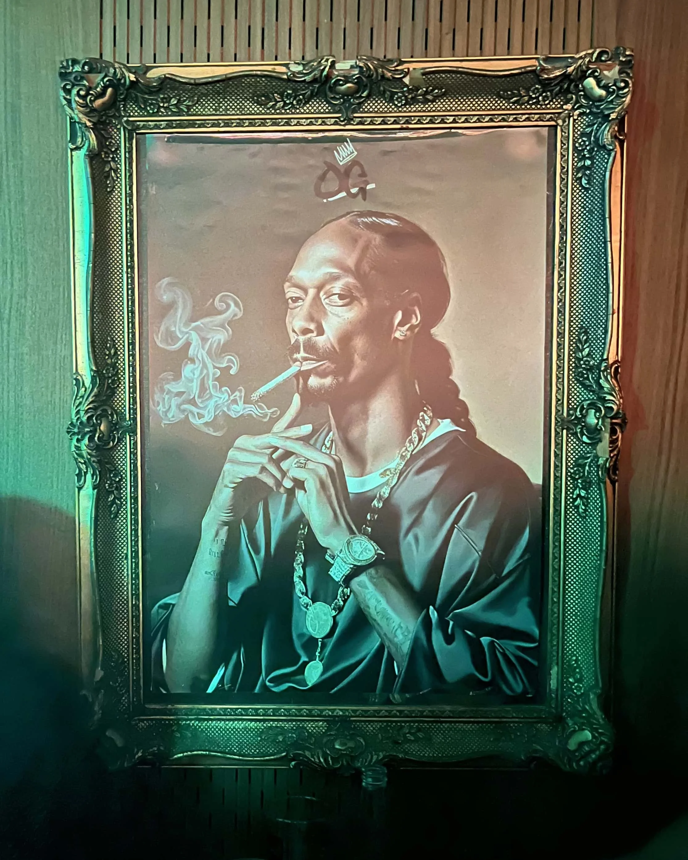 A framed old-school style picture of Snoop Dogg hanging on the wall at 97 Notes during a Hip Hop event.