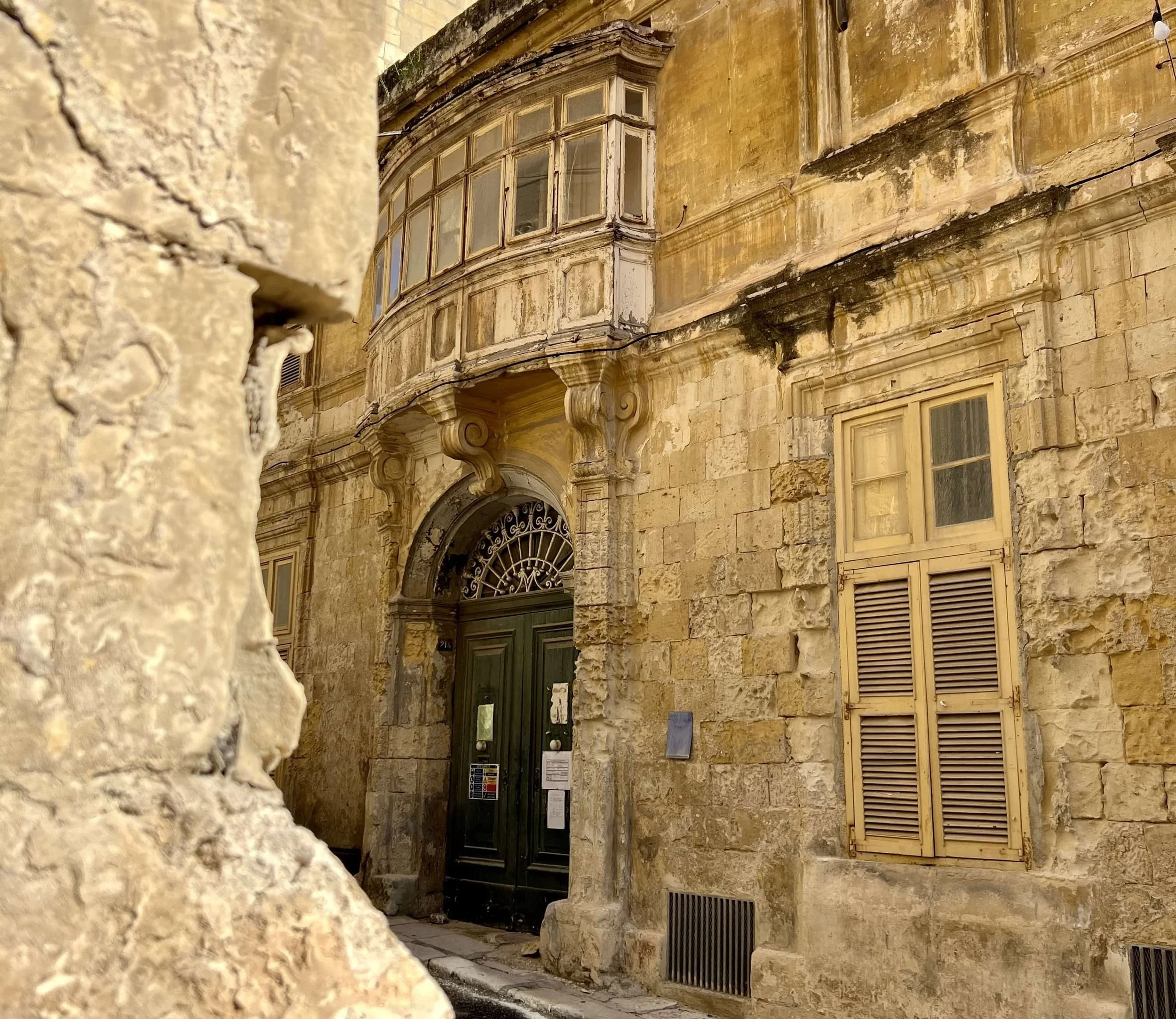 A historic limestone house in St. Ursula Street, Valletta, showing beautiful signs of weathering and erosion.