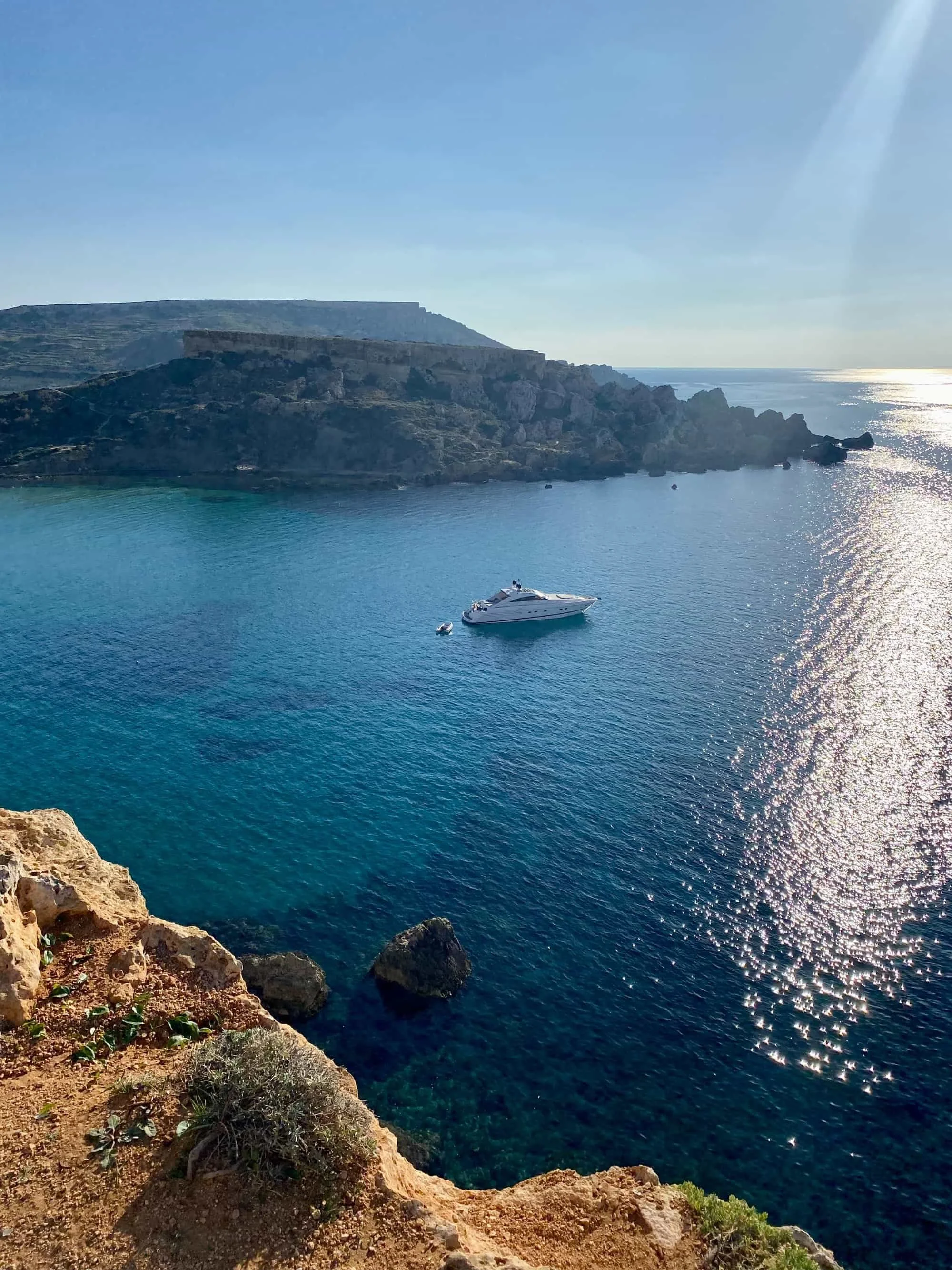 View from the hiking trail on the clay cliffs looking down at the deep turquoise sea.