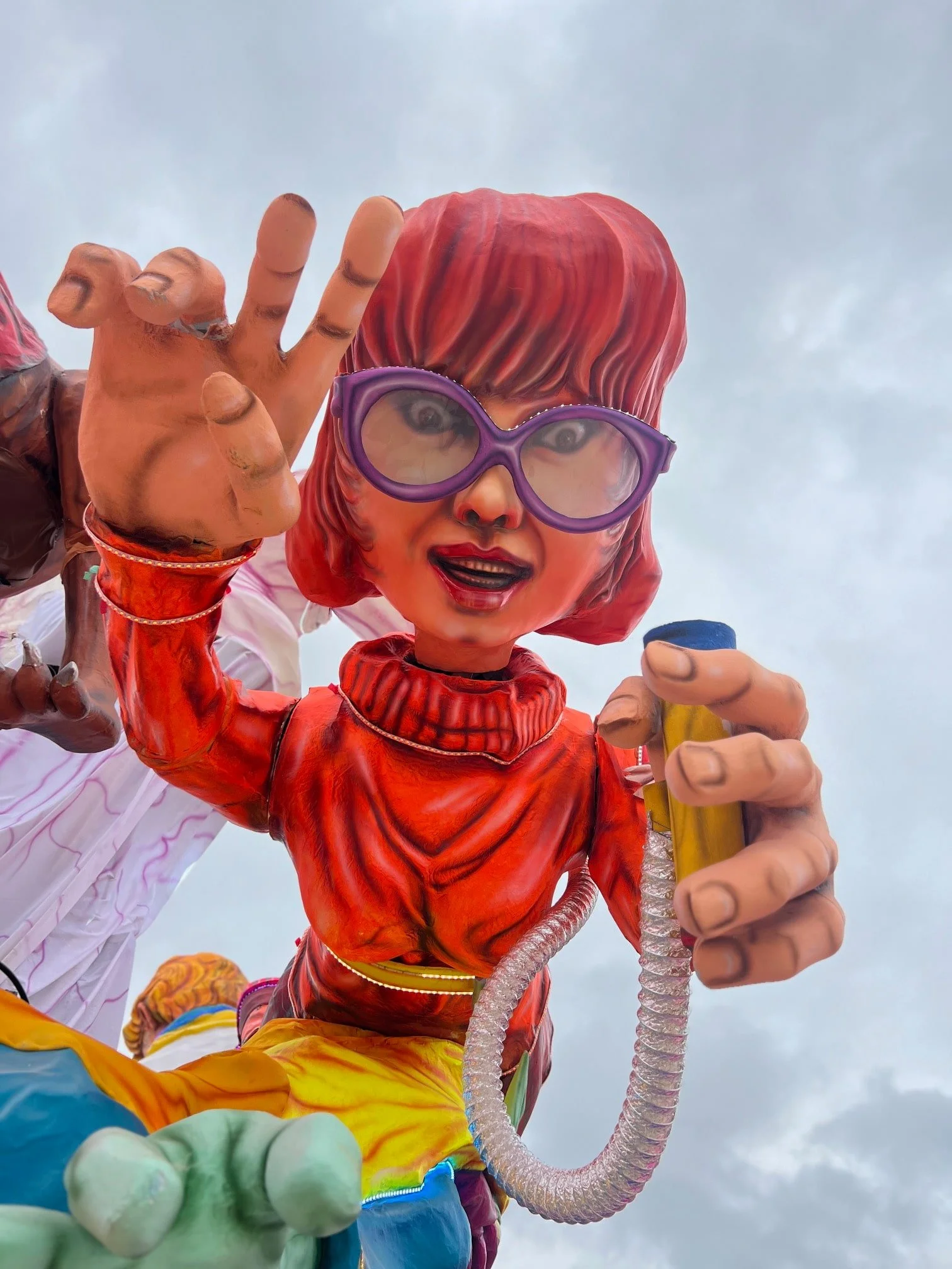 Giant Ghostbusters themed character figure with glasses on float.