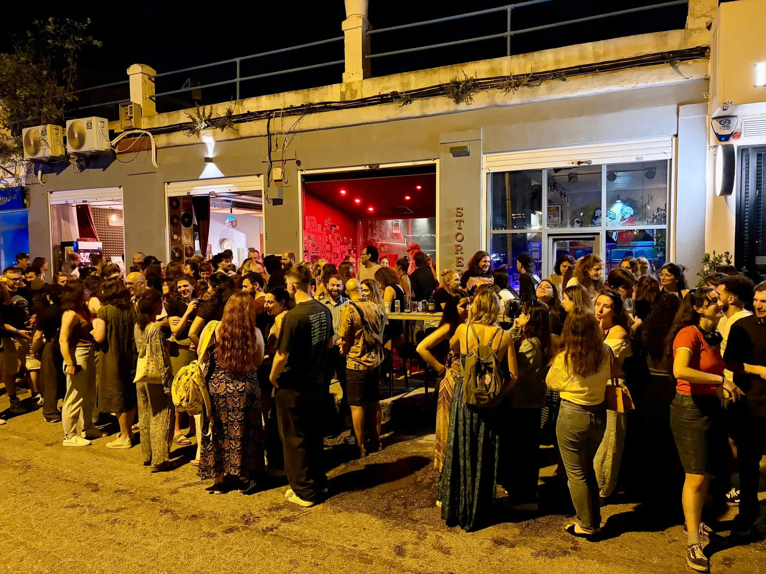 Crowded outdoor gathering for after-work drinks at Store Room in Ta' Xbiex, Malta.