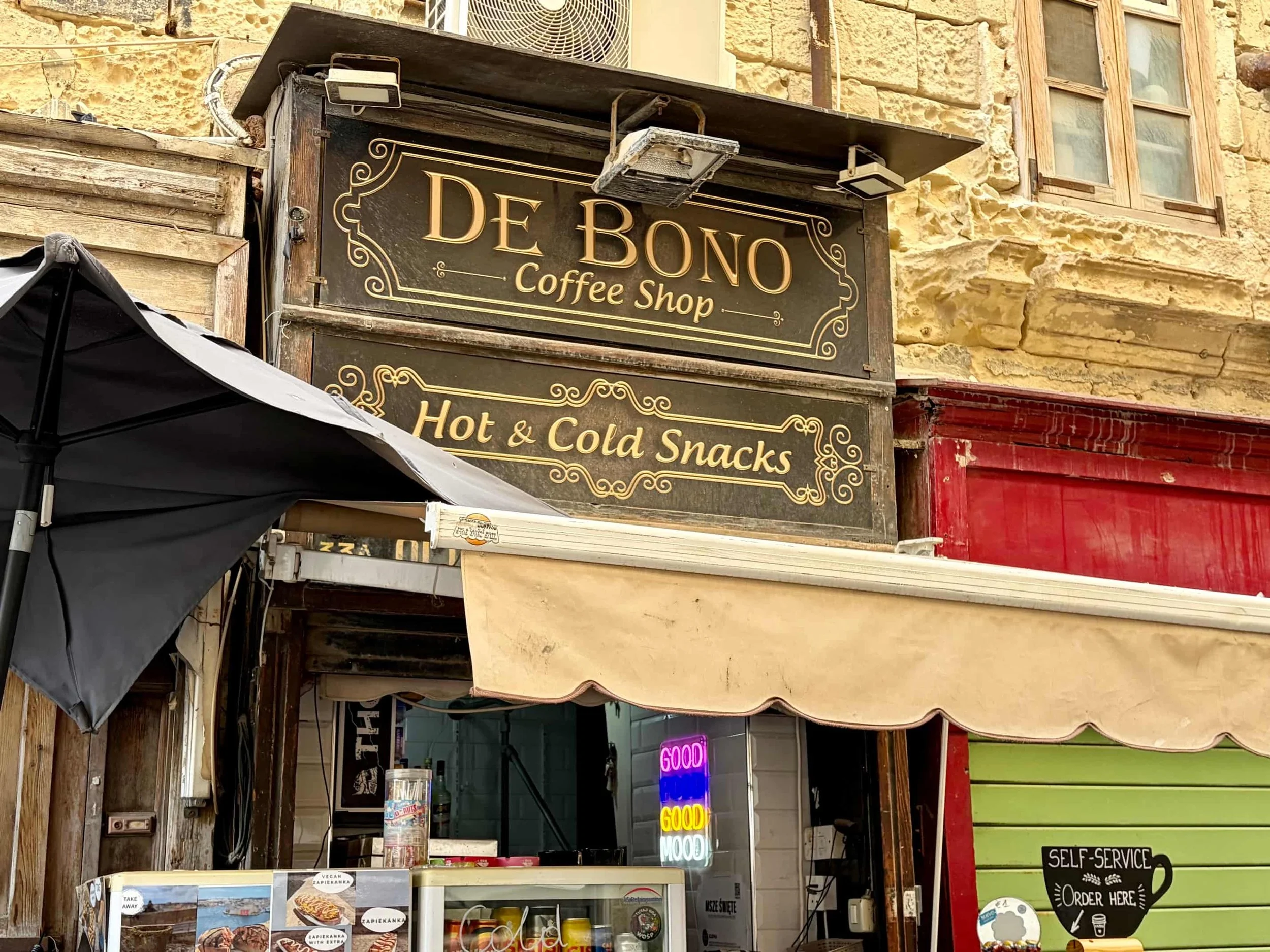 Eroded limestone facade of De Bono Coffee Shop in Valletta  Bildunterschrift: The unpretentious local storefront of De Bono Coffee Shop., Valletta.