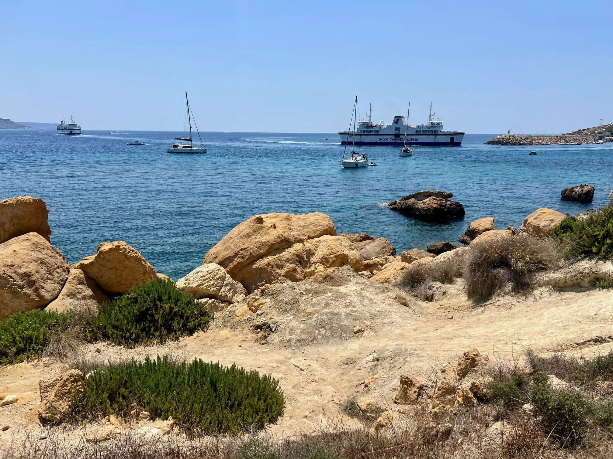 The Gozo Channel Ferry crossing between islands, viewed from the coastal path.