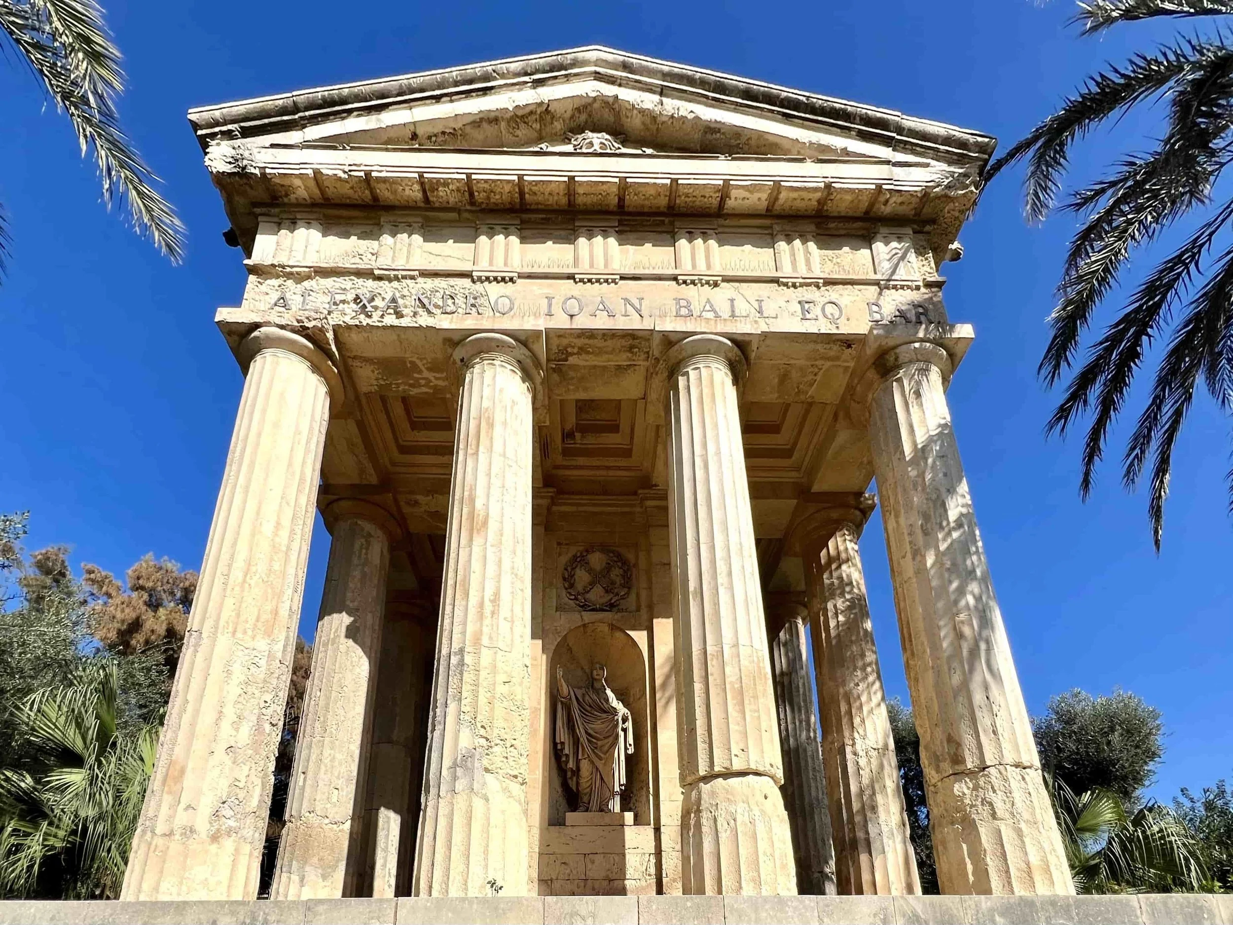 The neoclassical temple monument to Sir Alexander Ball inside the peaceful Lower Barrakka Gardens.