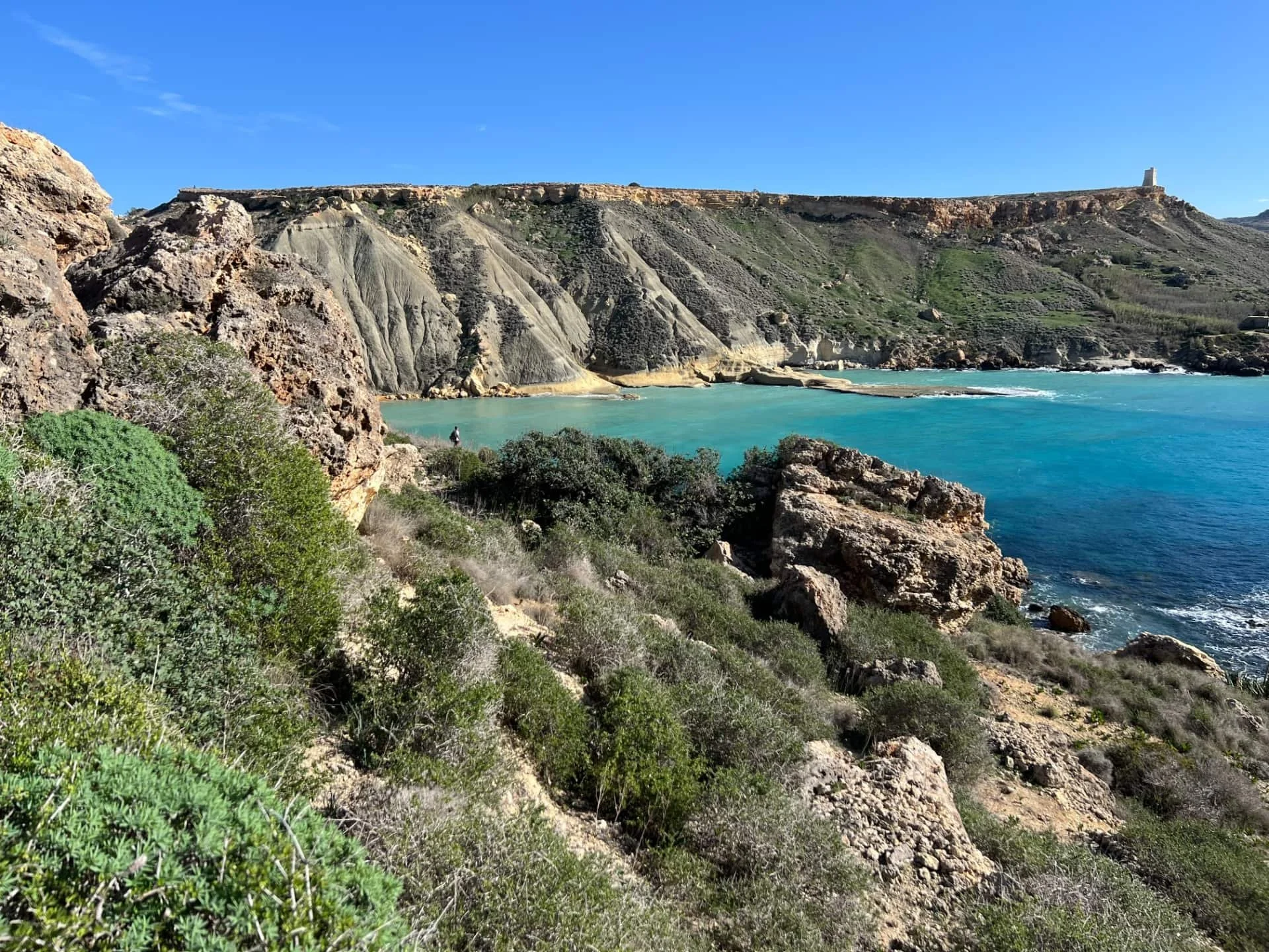 Green coastal vegetation on the cliffs with rocky landscapes near Lippia Tower.