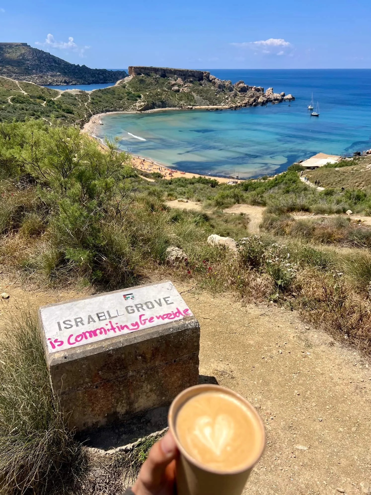 View towards Riviera Beach with route marker in the foreground displaying "Israel comitts genocide".
