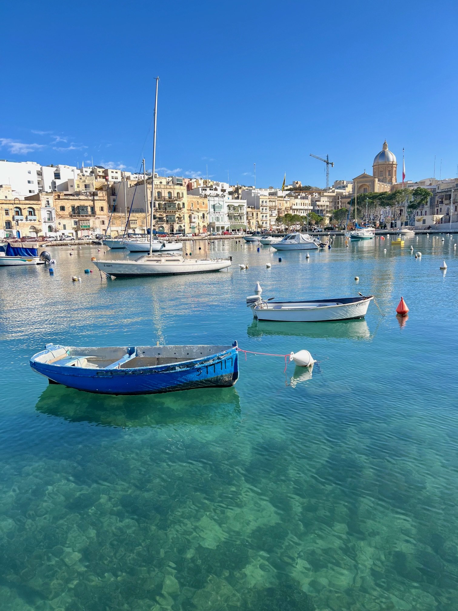 View from the promenade looking towards Kalkara Creek with traditional fishing boats in the foreground.