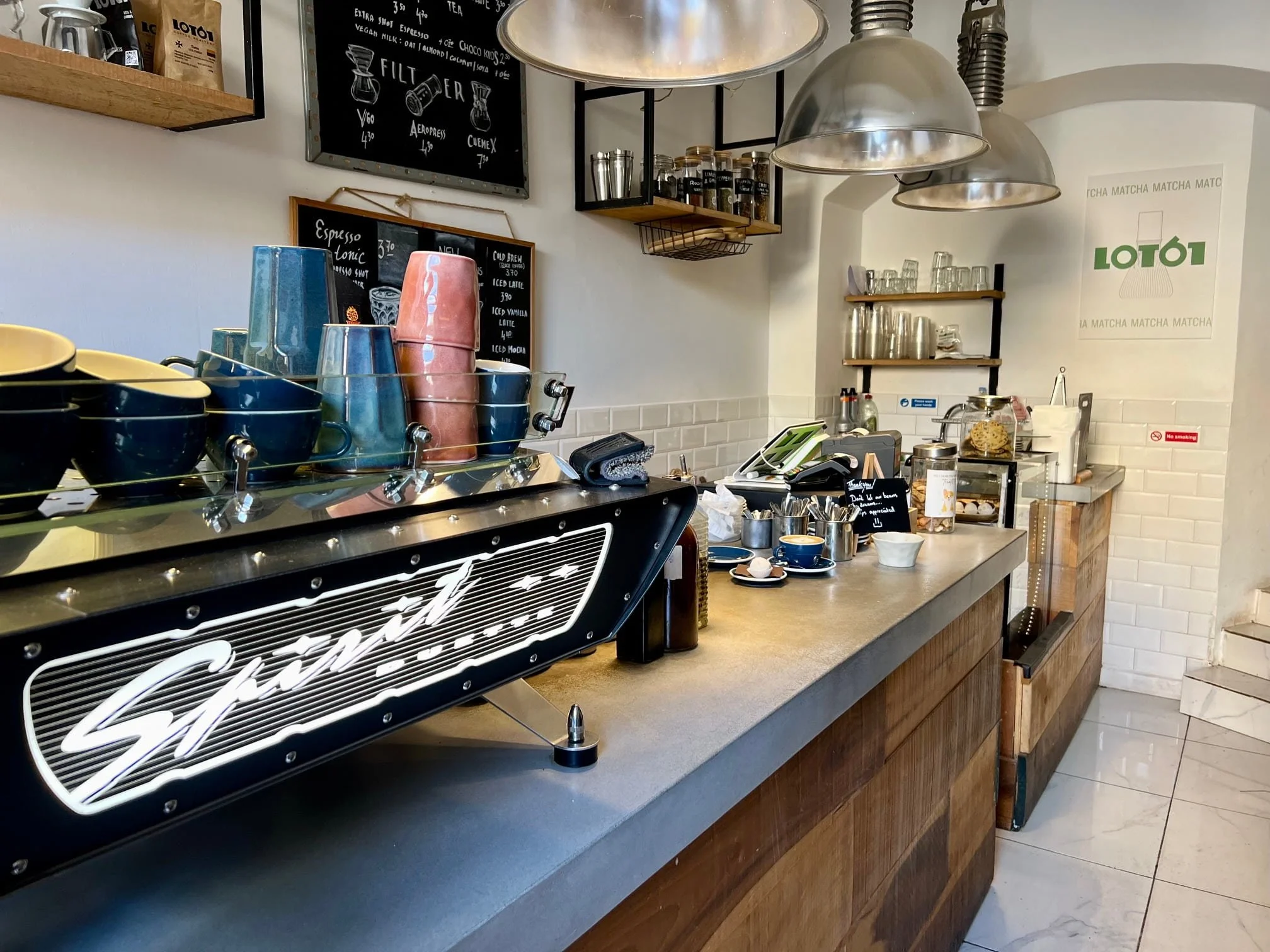 Professional espresso machine and bar setup inside Lot61 Coffee Roasters, Valletta.