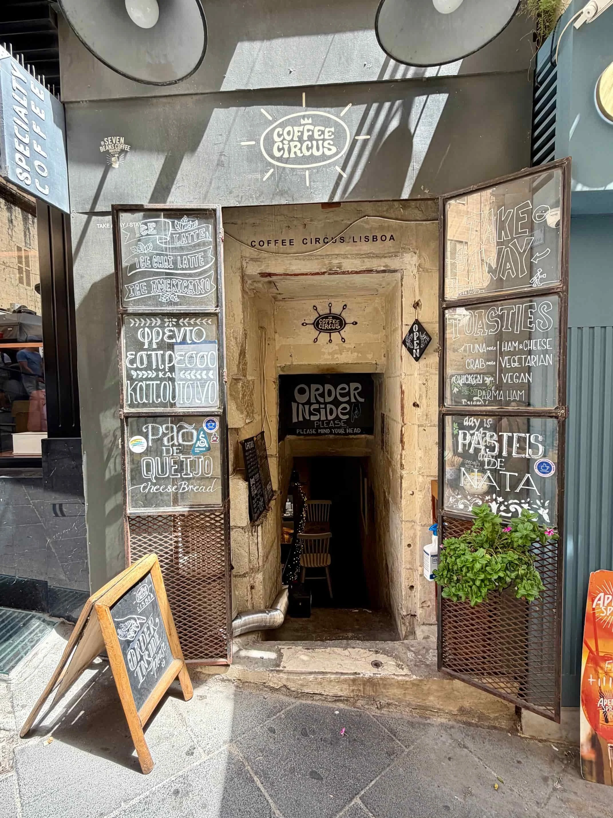 Entrance door featuring painted glass artwork at Coffee Circus Lisboa, Valletta.